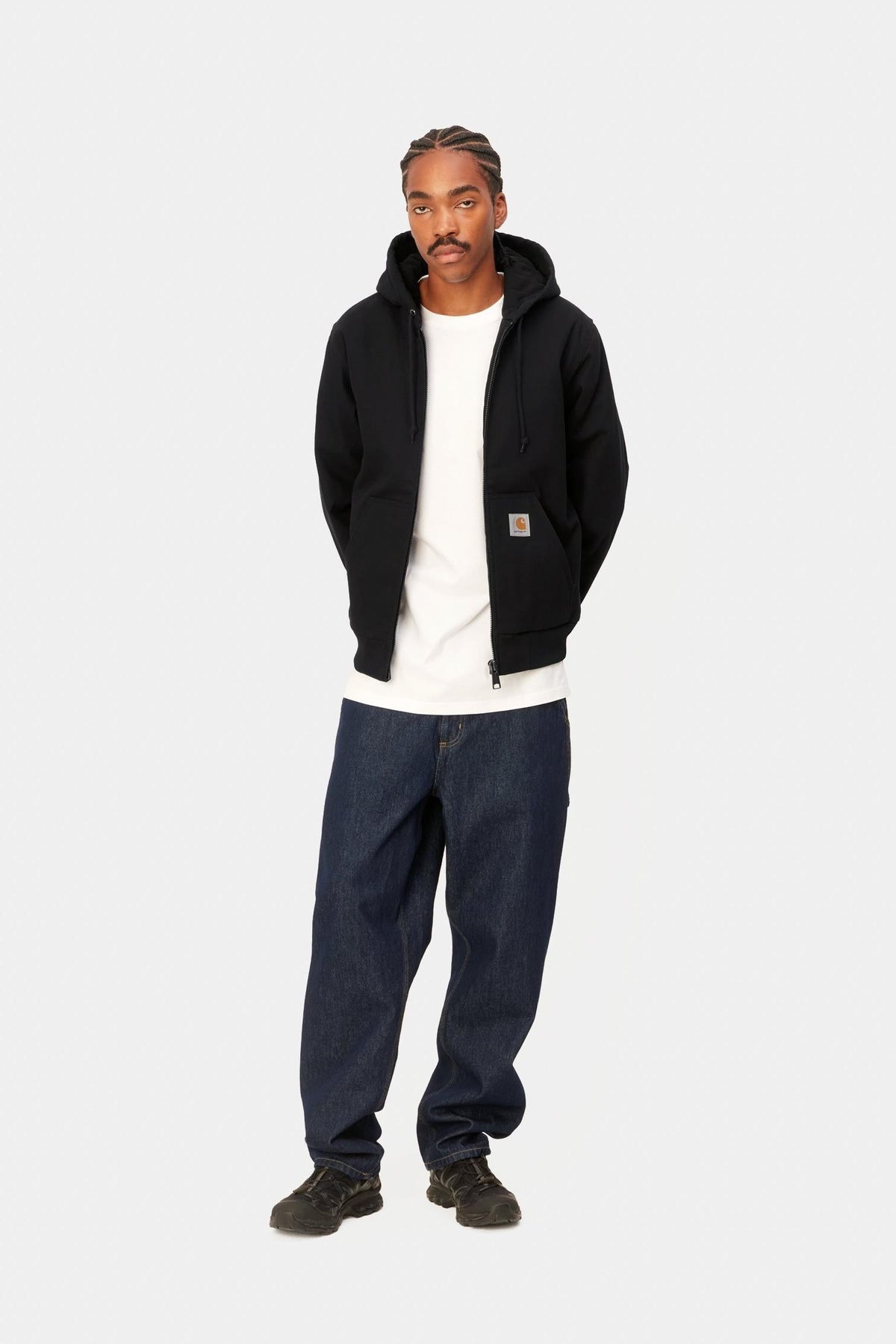 Full outfit view of the Carhartt WIP Active Jacket in Black Rigid worn with jeans