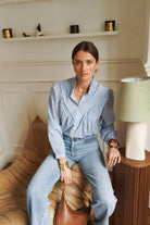 Women's blue and white fine striped shirt front flat view