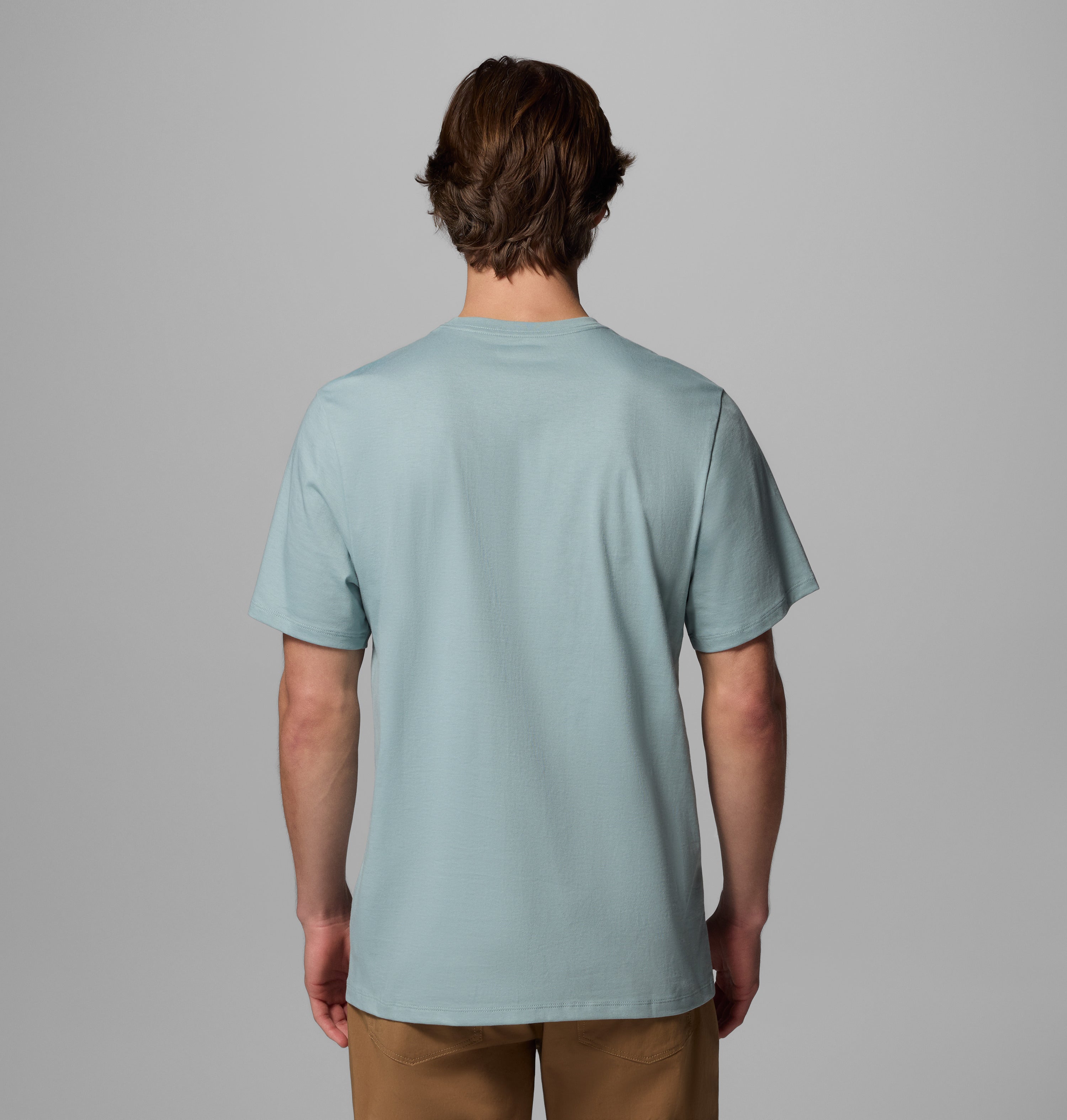 Back view of Columbia's CSC Seasonal Graphic Tee in Crushed Blue (Heavenly Stacked Gem) with straight hem and short sleeves.