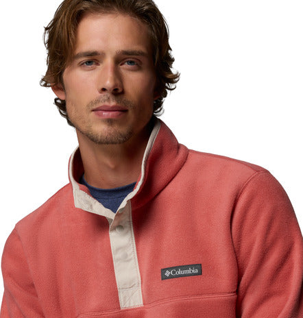 Man wearing a red fleece pullover with Columbia logo on a white background