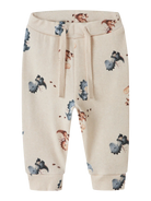 Beige pants with dinosaur pattern on a white background