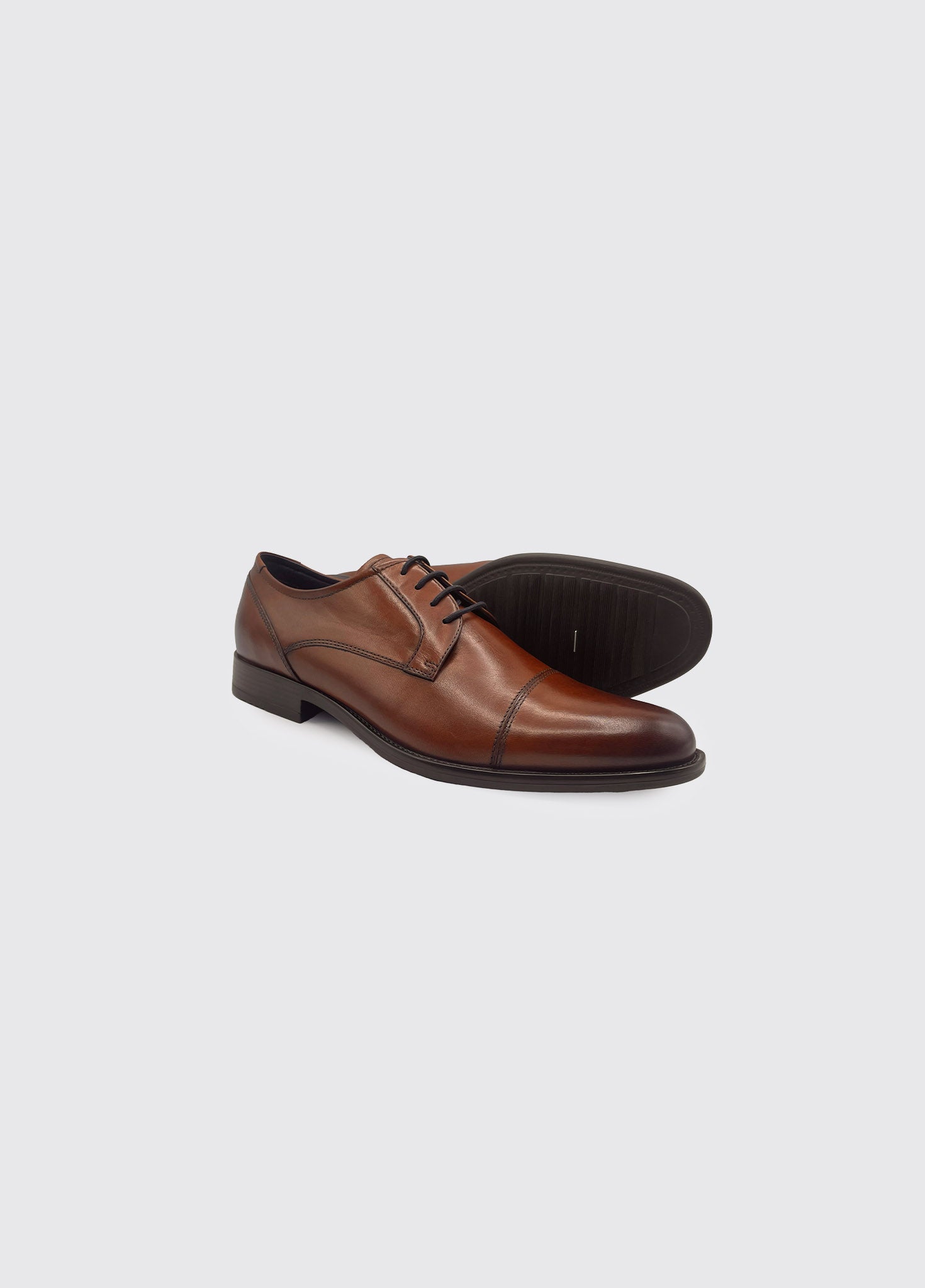 Derek whiskey Brown leather dress shoes on a light gray background