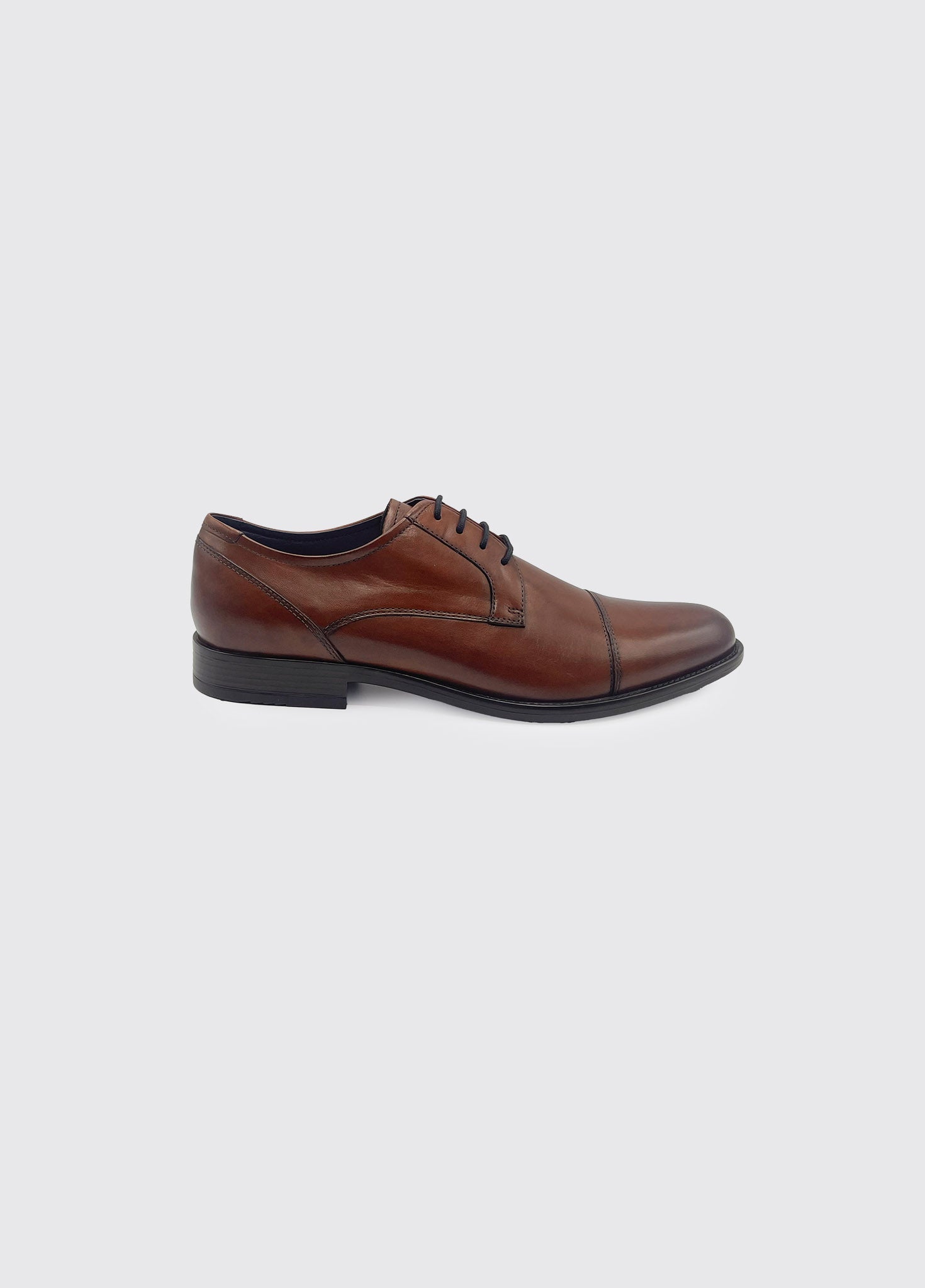 Derek whiskey Brown leather dress shoe on a light gray background