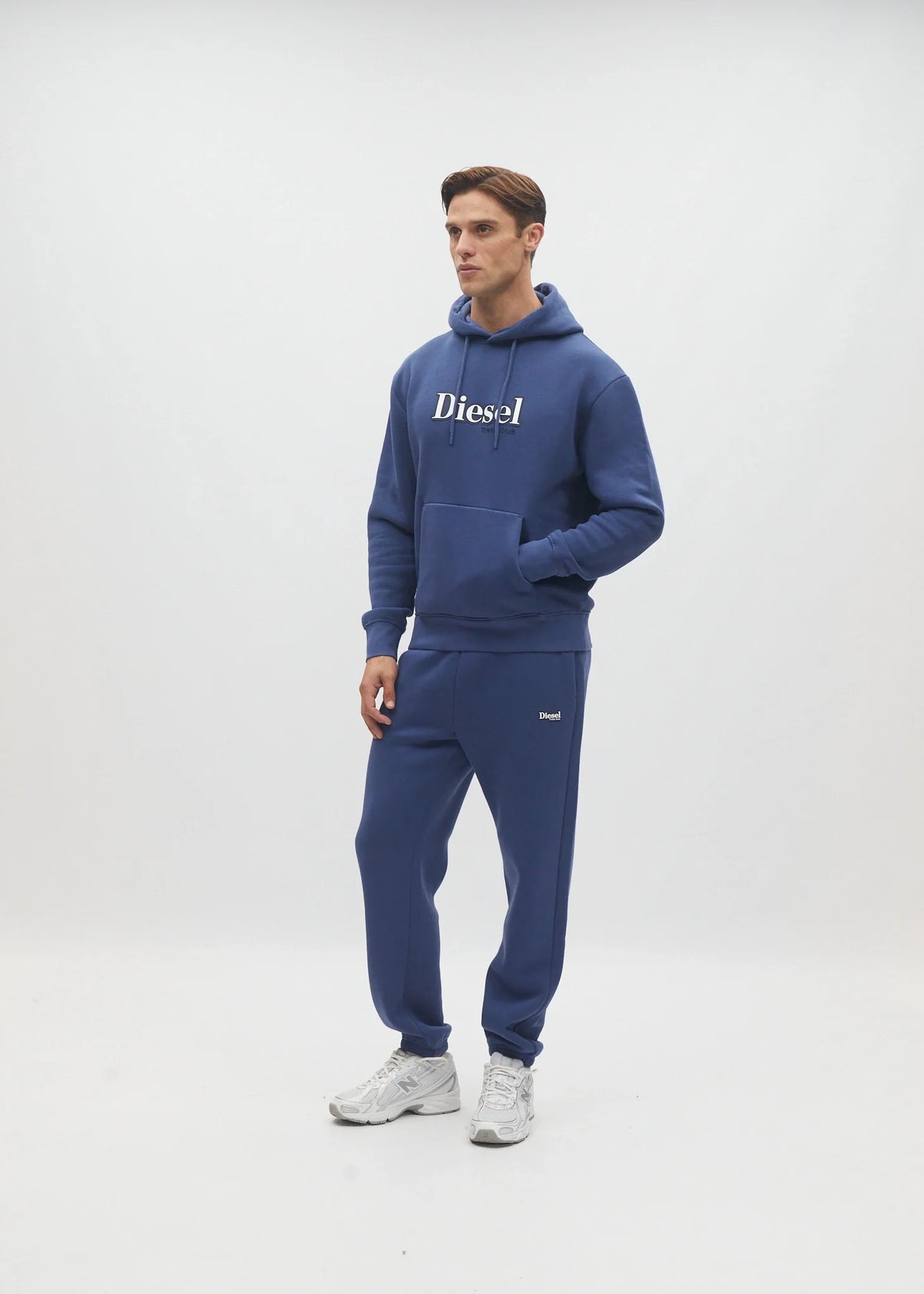 Diesel Walt Hoodie in Hugo Blue, three-quarter model view with hands in the front pocket.