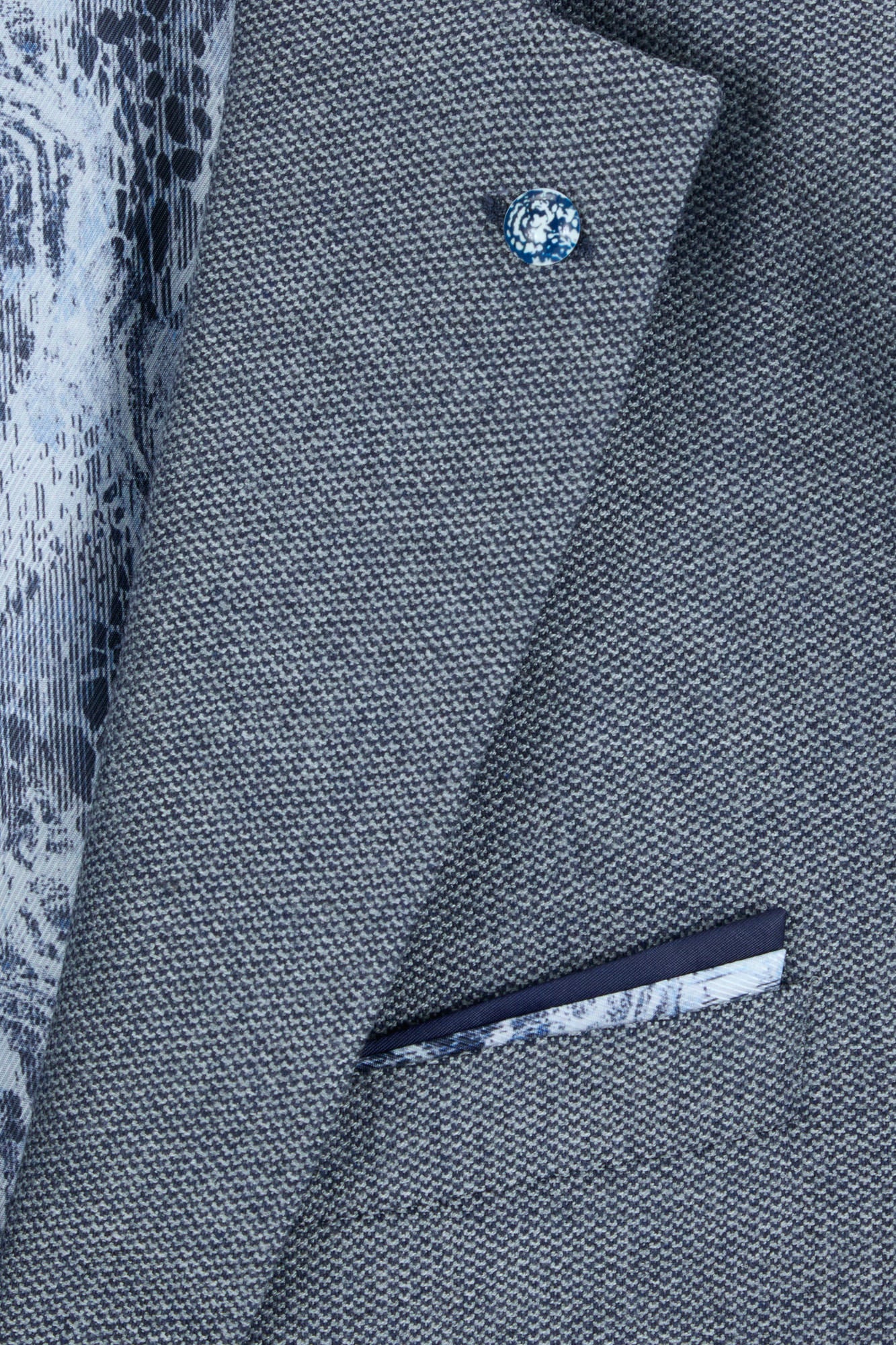 Close-up of the Pisa Navy blazer lapel pin, pocket square and lining