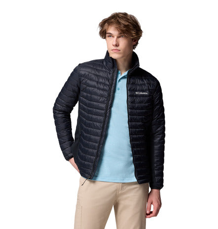 Person wearing a black puffer jacket with Columbia logo on a white background