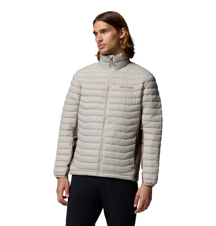 Man wearing a grey puffer jacket on a white background