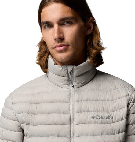 Man wearing a light grey Columbia jacket on a white background