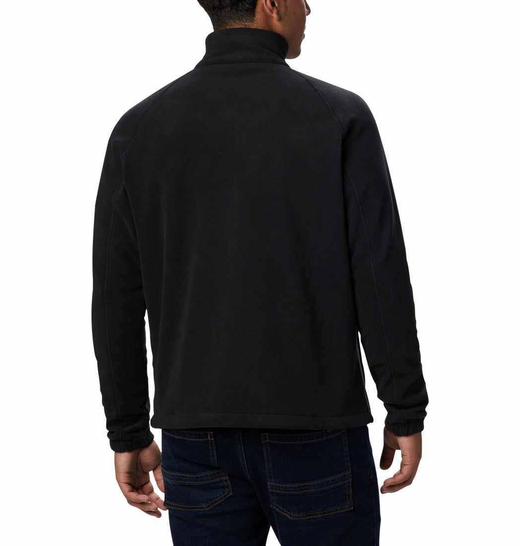 Person wearing a black long-sleeve fleece on a white background