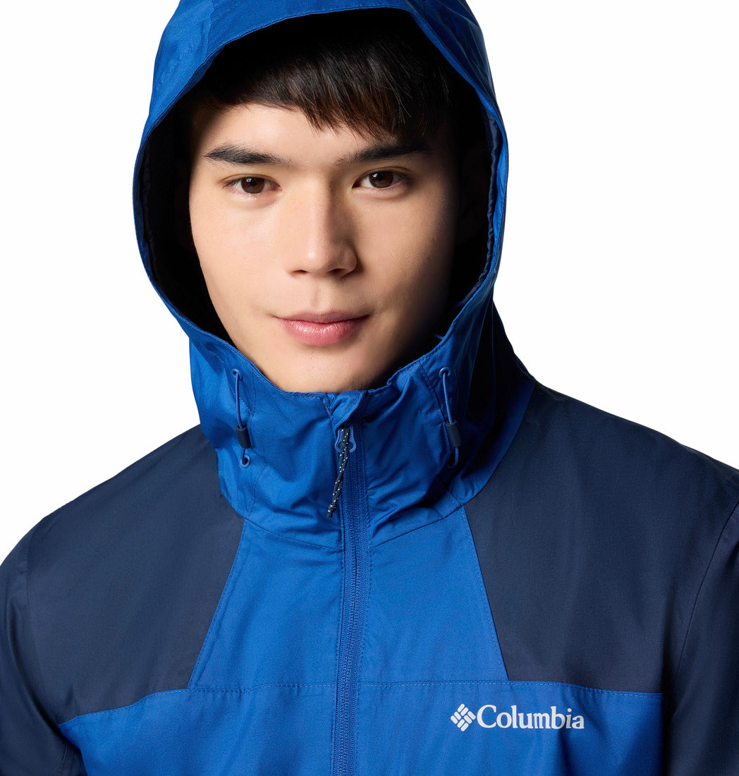 Person wearing a blue and navy Columbia jacket on a white background