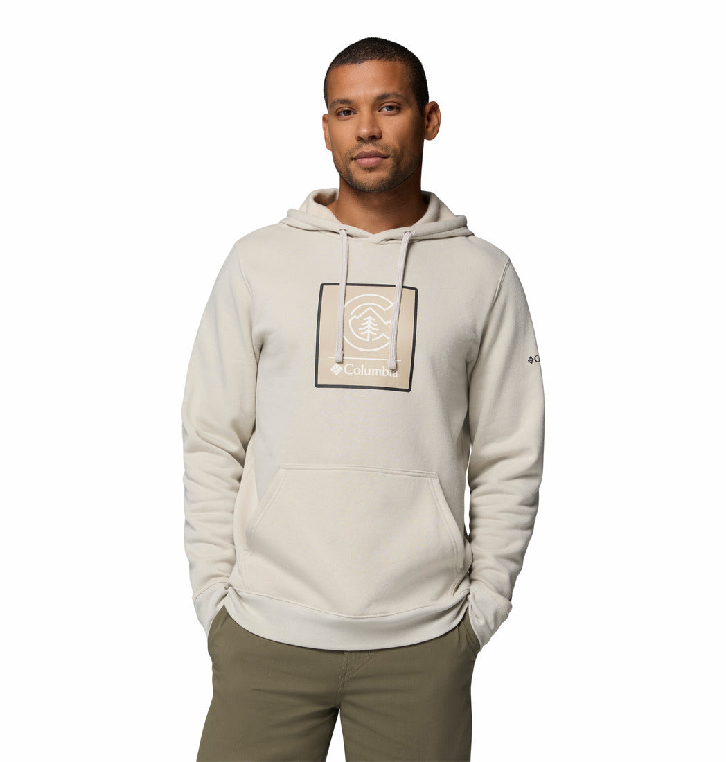 Man wearing a beige hoodie with a logo on a white background