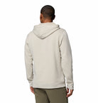 Person wearing a beige hoodie from behind on a white background