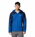 Person wearing a blue and navy jacket with Columbia logo on a white background