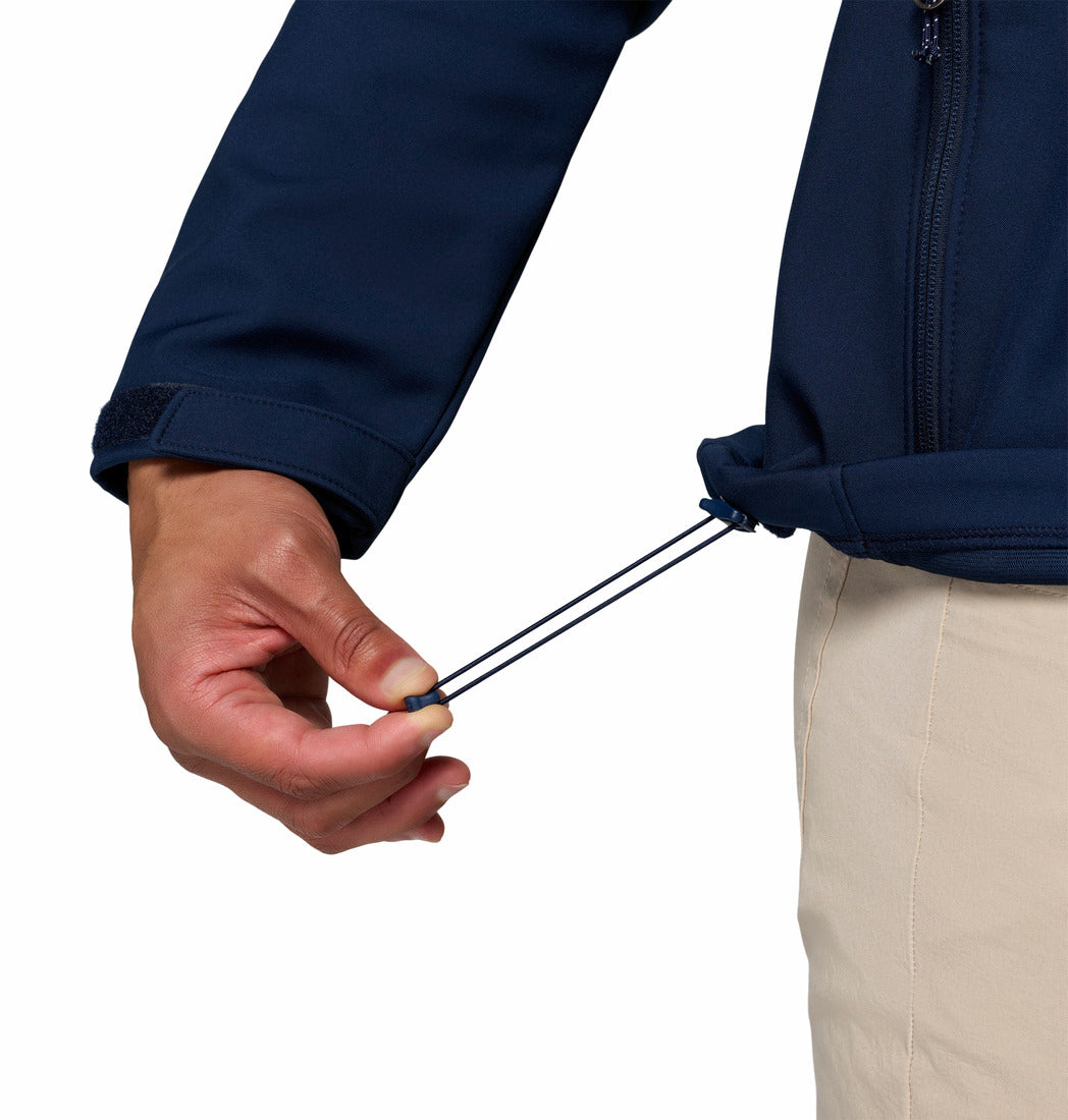 Close up of a man wearing a navy blue jacket with Columbia logo on a white background