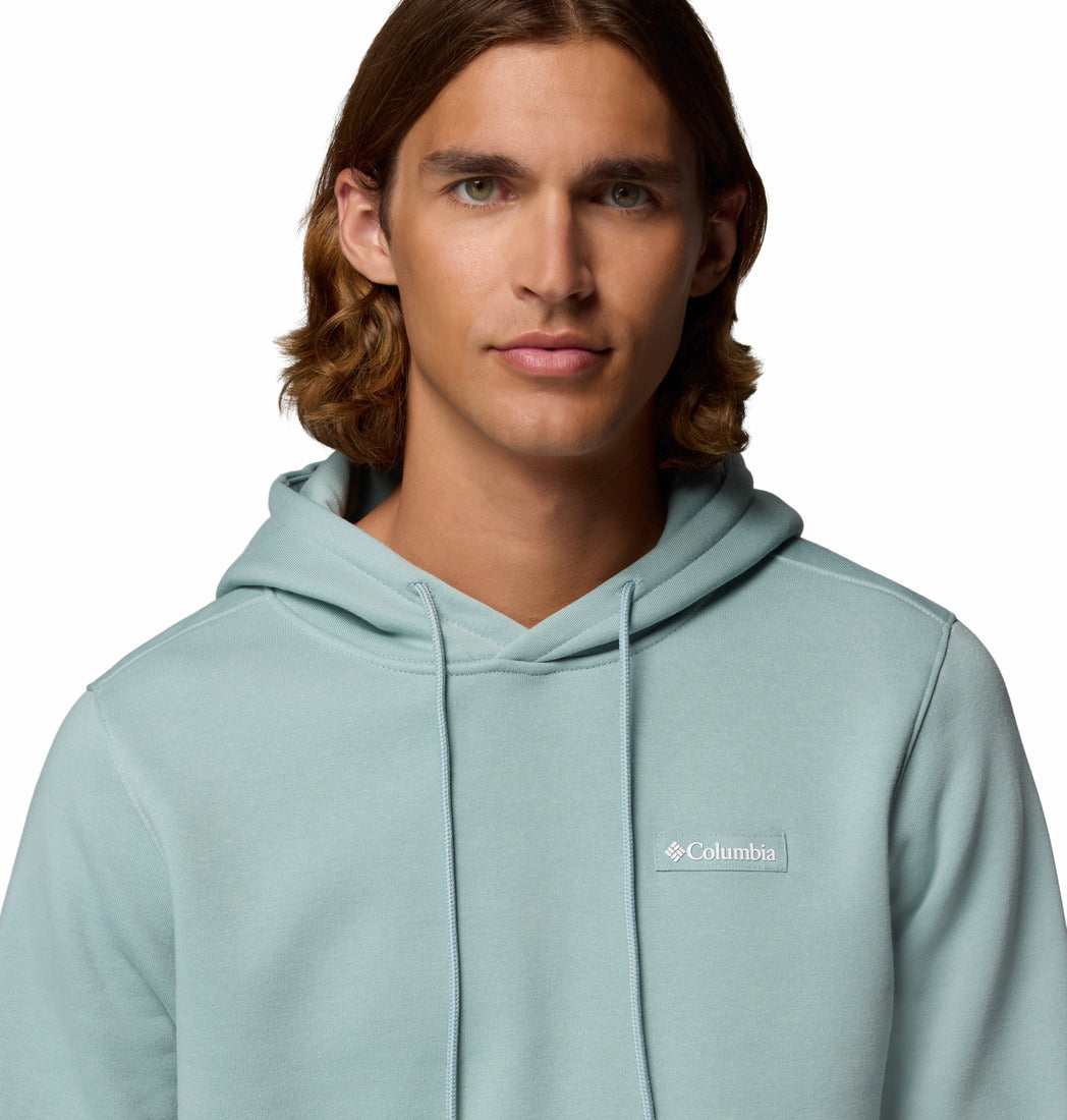Man wearing a light blue hoodie with Columbia logo on a white background