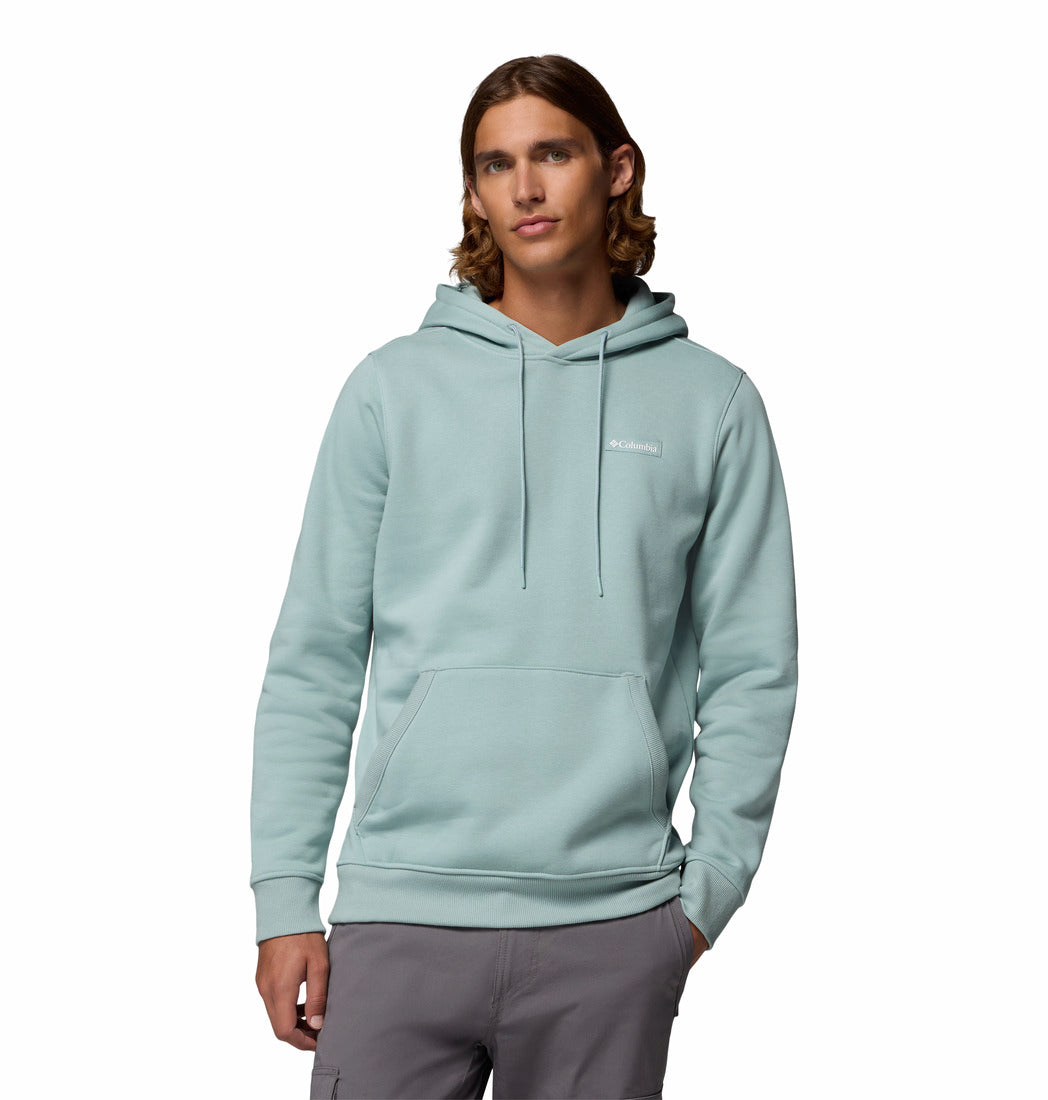 Person wearing a light blue hoodie with a brand logo on a white background