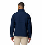 Man wearing a navy blue jacket on a white background