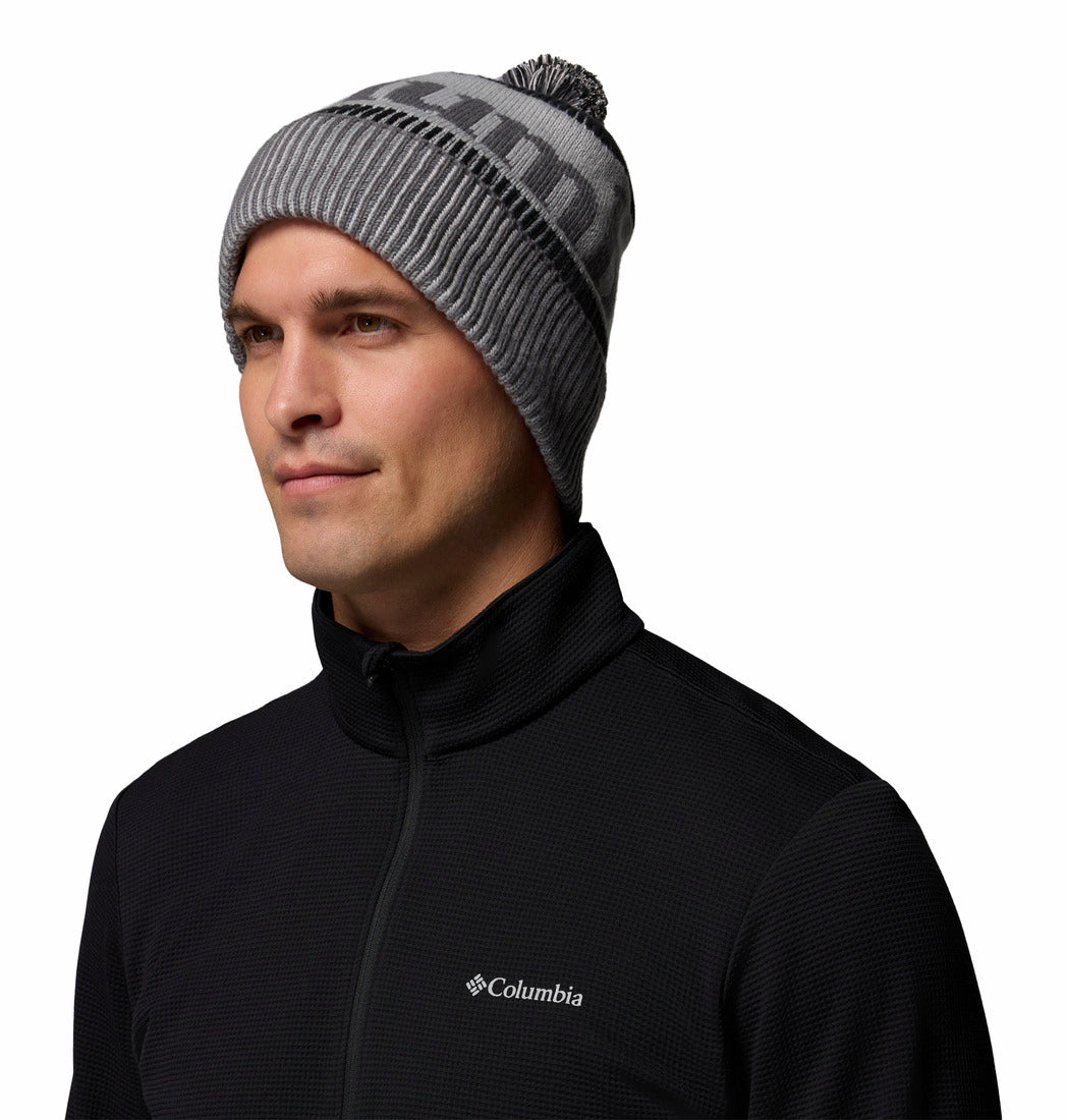 Man wearing a gray beanie and black Columbia jacket on a white background