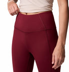 Maroon leggings worn by a person on a white background