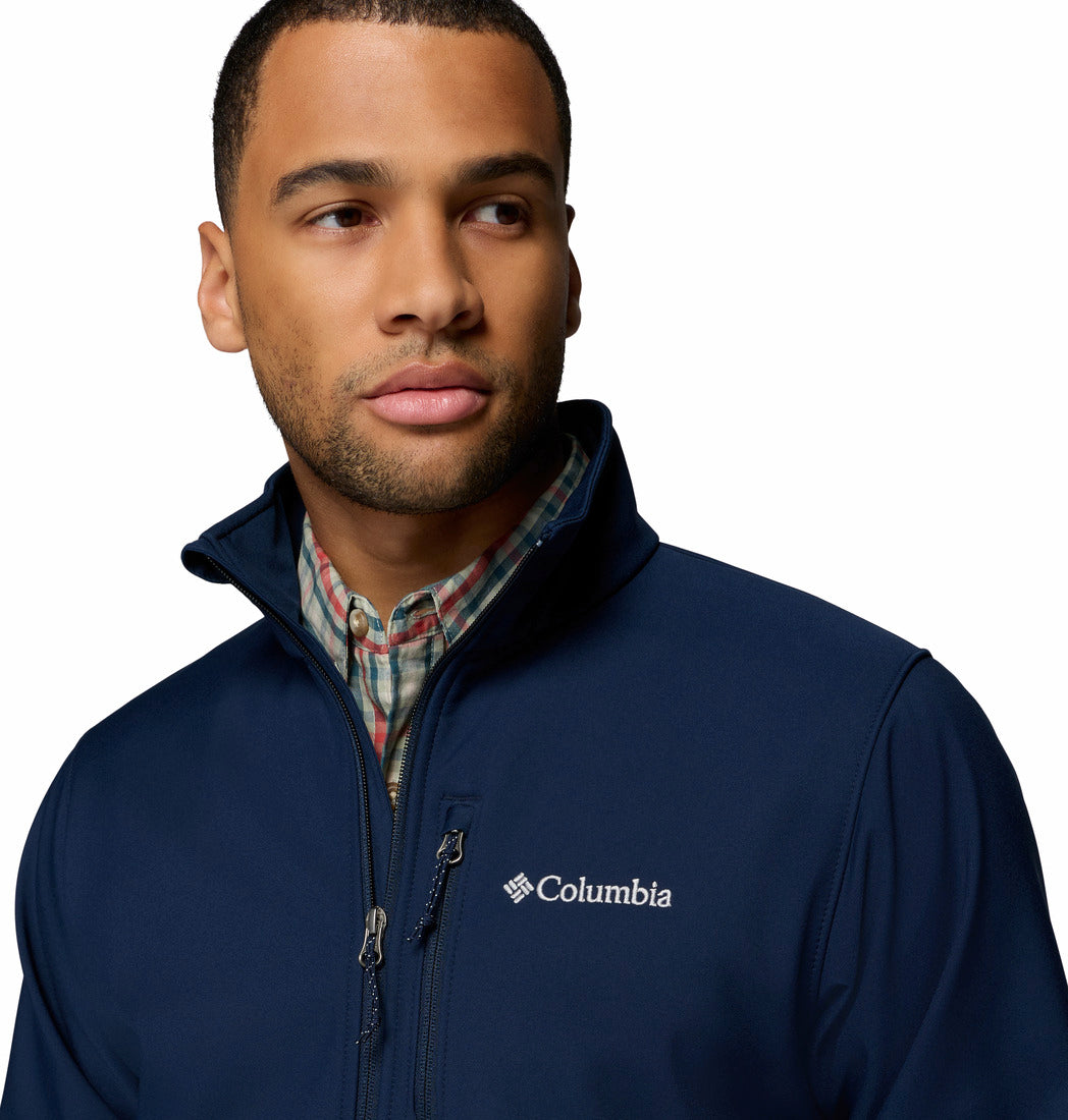 Man wearing a navy Columbia jacket on a white background