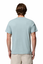 Person wearing a light blue t-shirt on a white background