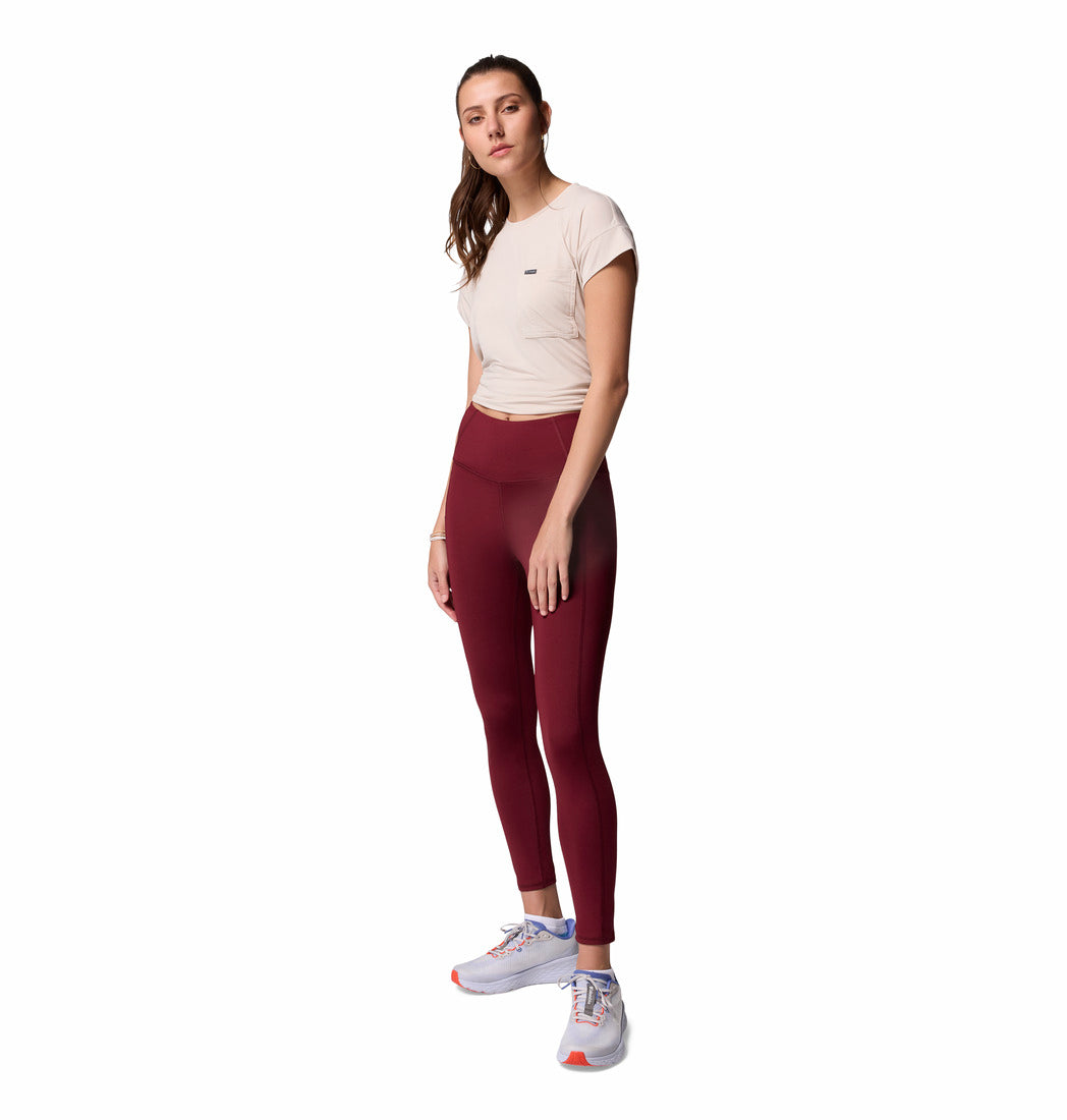Woman wearing a white t-shirt and maroon leggings on a white background