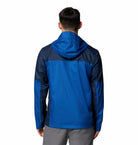 Blue and black jacket worn by a person on a white background