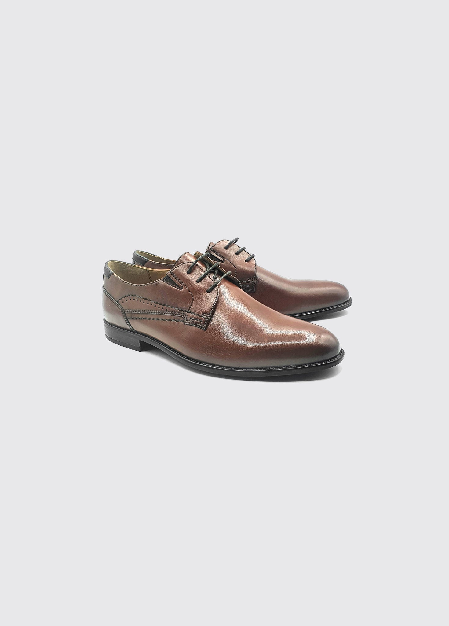 Pair of brown leather shoes on a white background