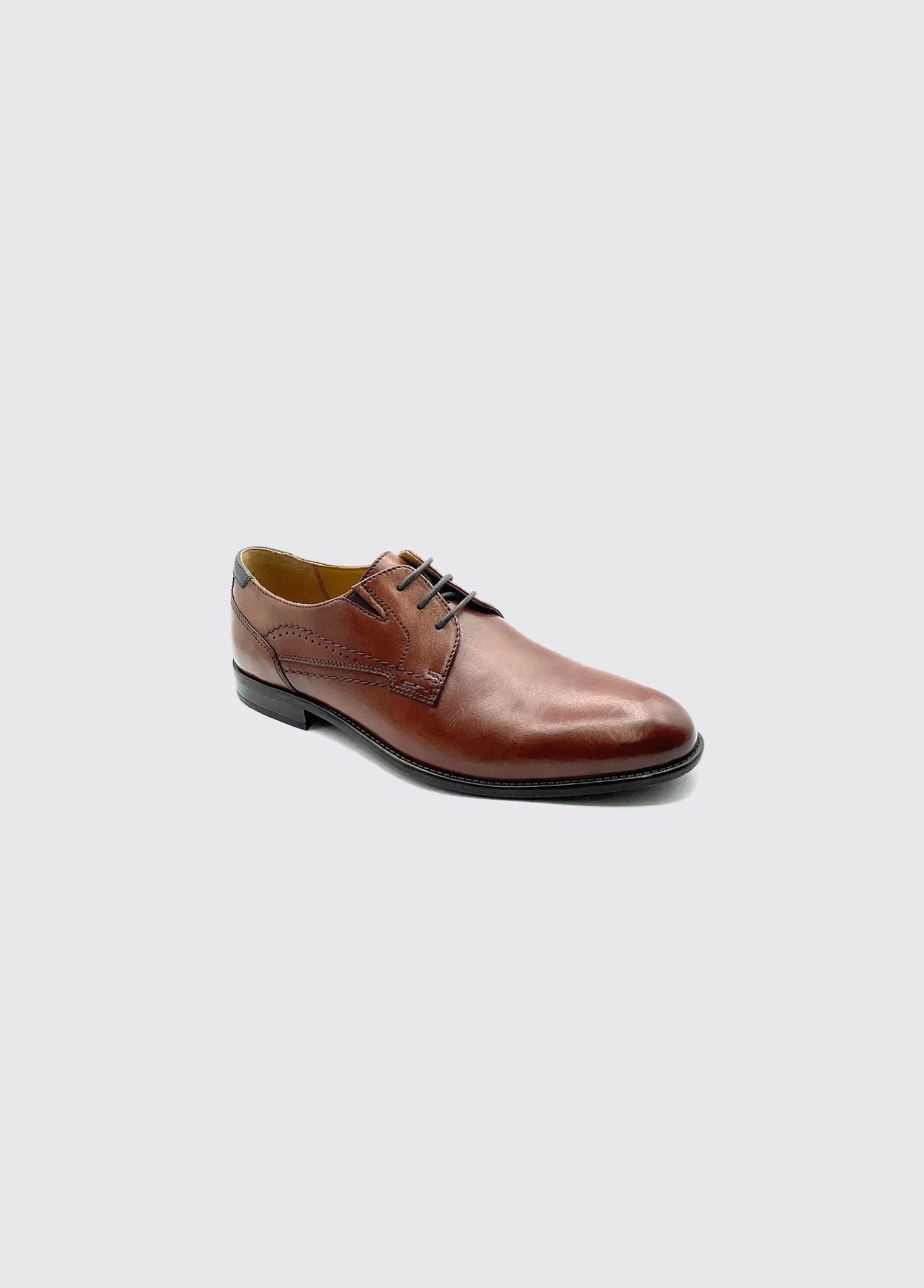 Brown leather dress shoe on a light gray background-Right side view