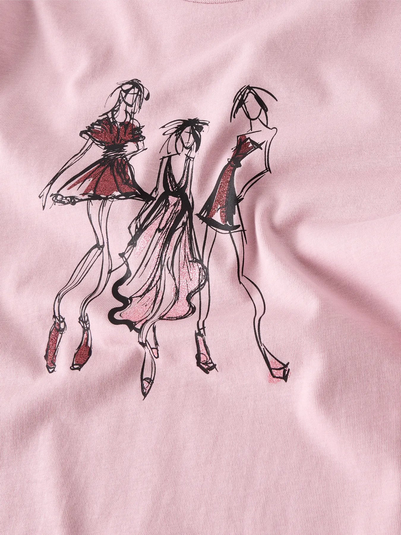 Pink fabric with black and red sketches of three women in dresses.
