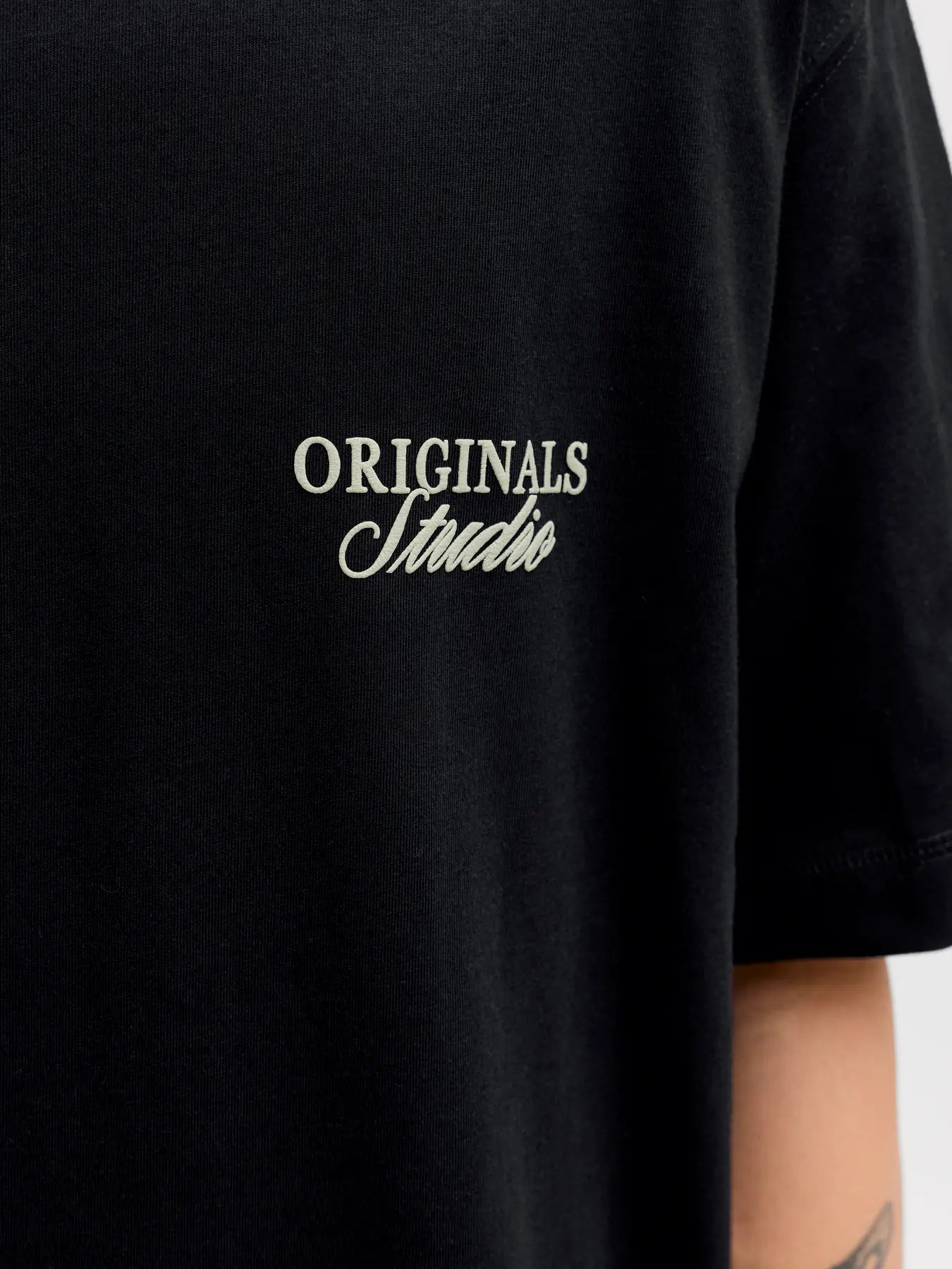 Black t-shirt with 'ORIGINALS Studio' text on a plain background