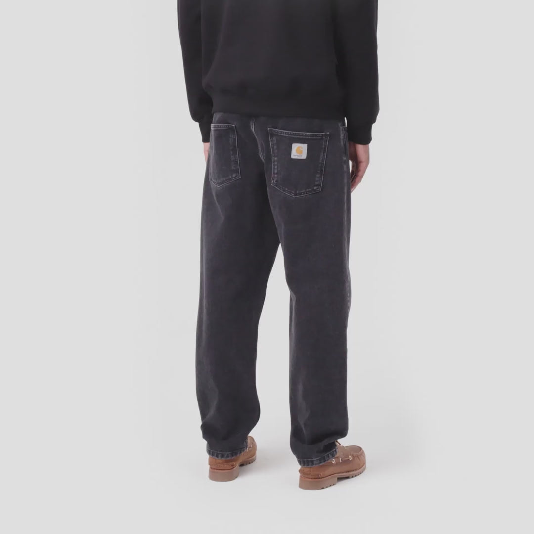 Video of a man wearing black stone wash Newel jean pants and a black Carhartt sweatshirt