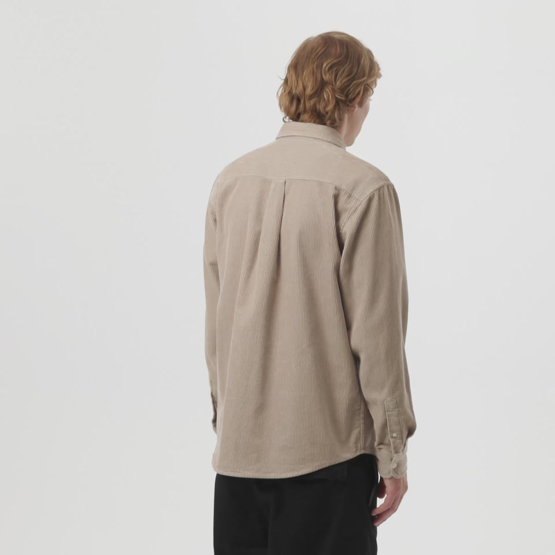 Man wearing a beige corduroy button-up shirt