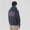 Person wearing a dark blue hoodie with purple front and back print