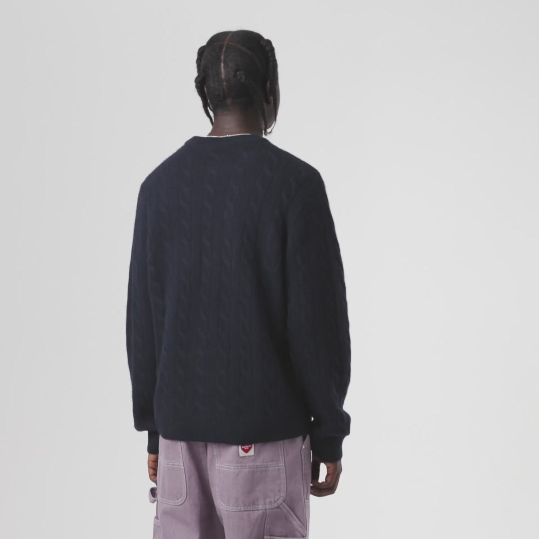 Man wearing a Signature Sweater-Deep Night / Glassy Pink