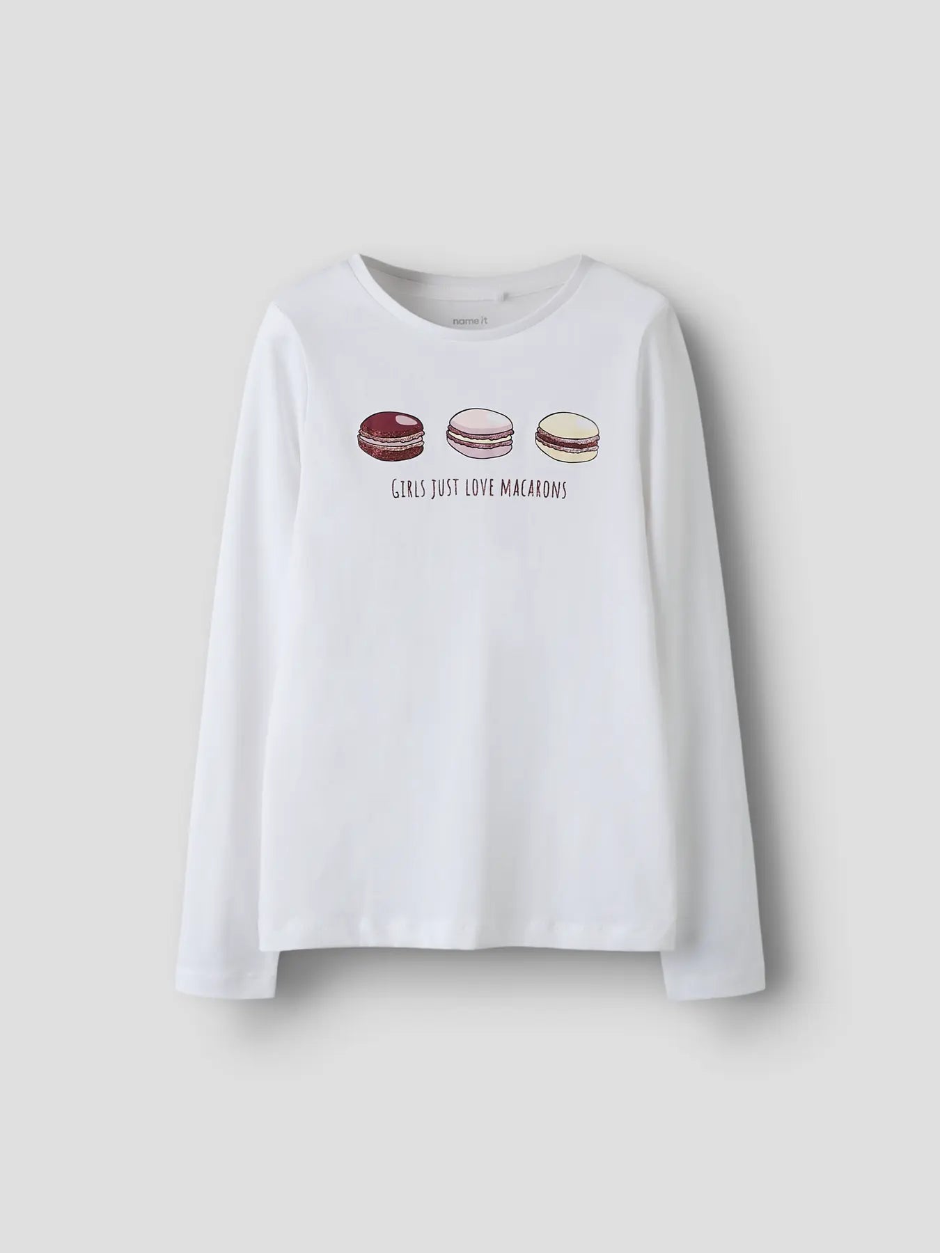 White long-sleeve shirt with macaron graphics and text on a plain background