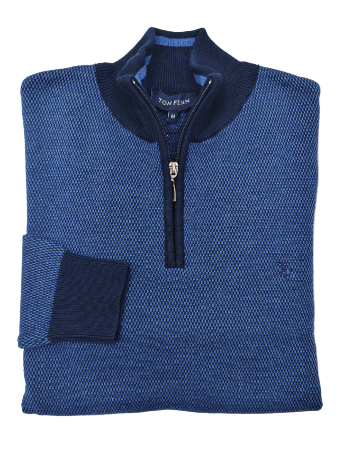 Folded blue sweater with a quarter zip on a white background