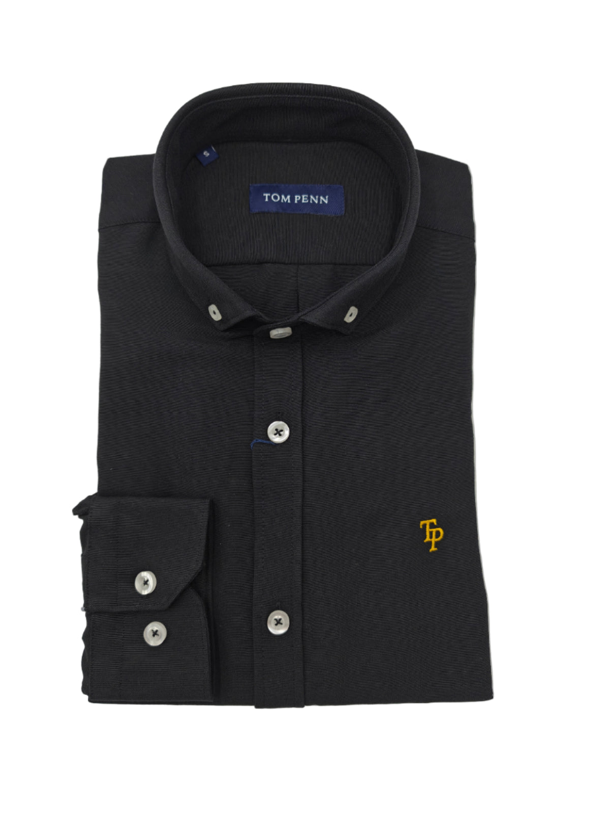 Folded black shirt with 'Tom Penn' branding on a light gray background