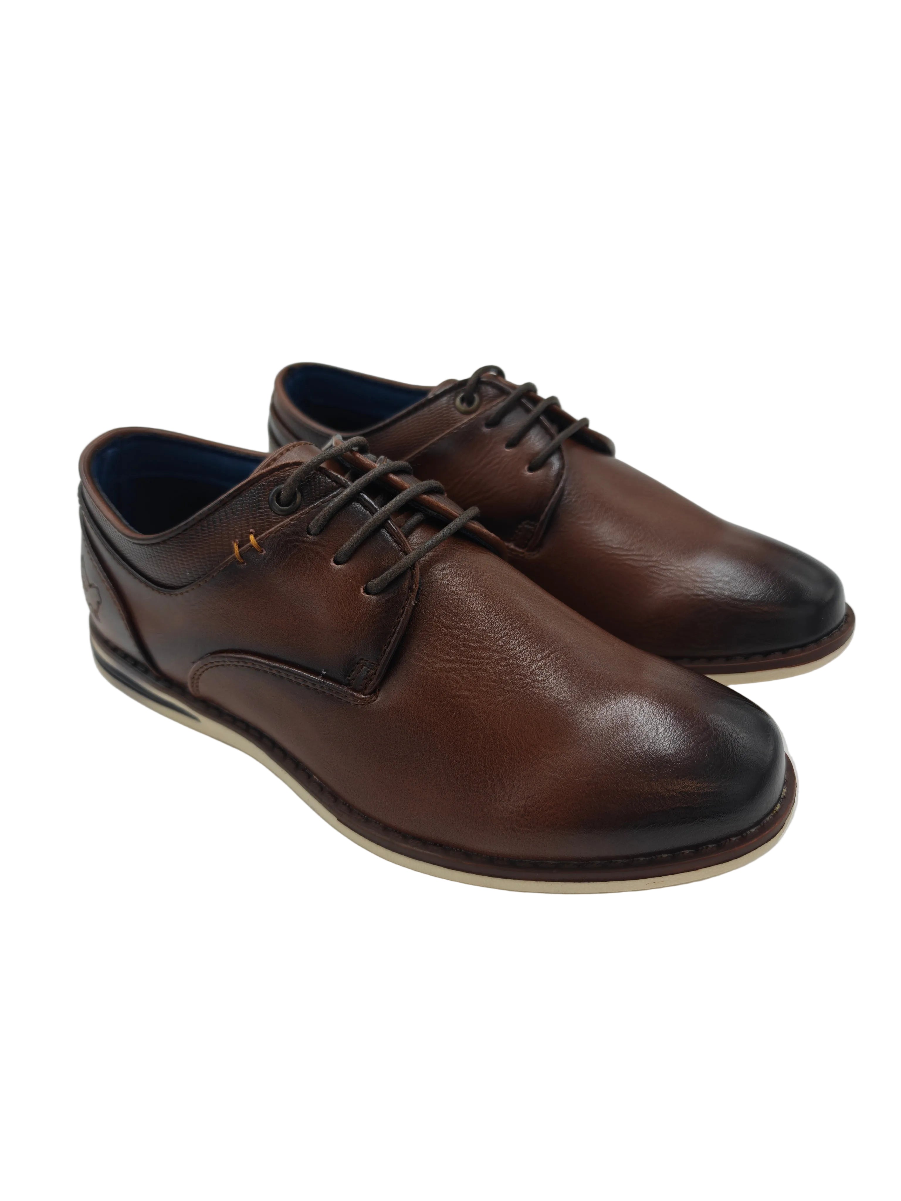 Pair of brown leather shoes on a white surface