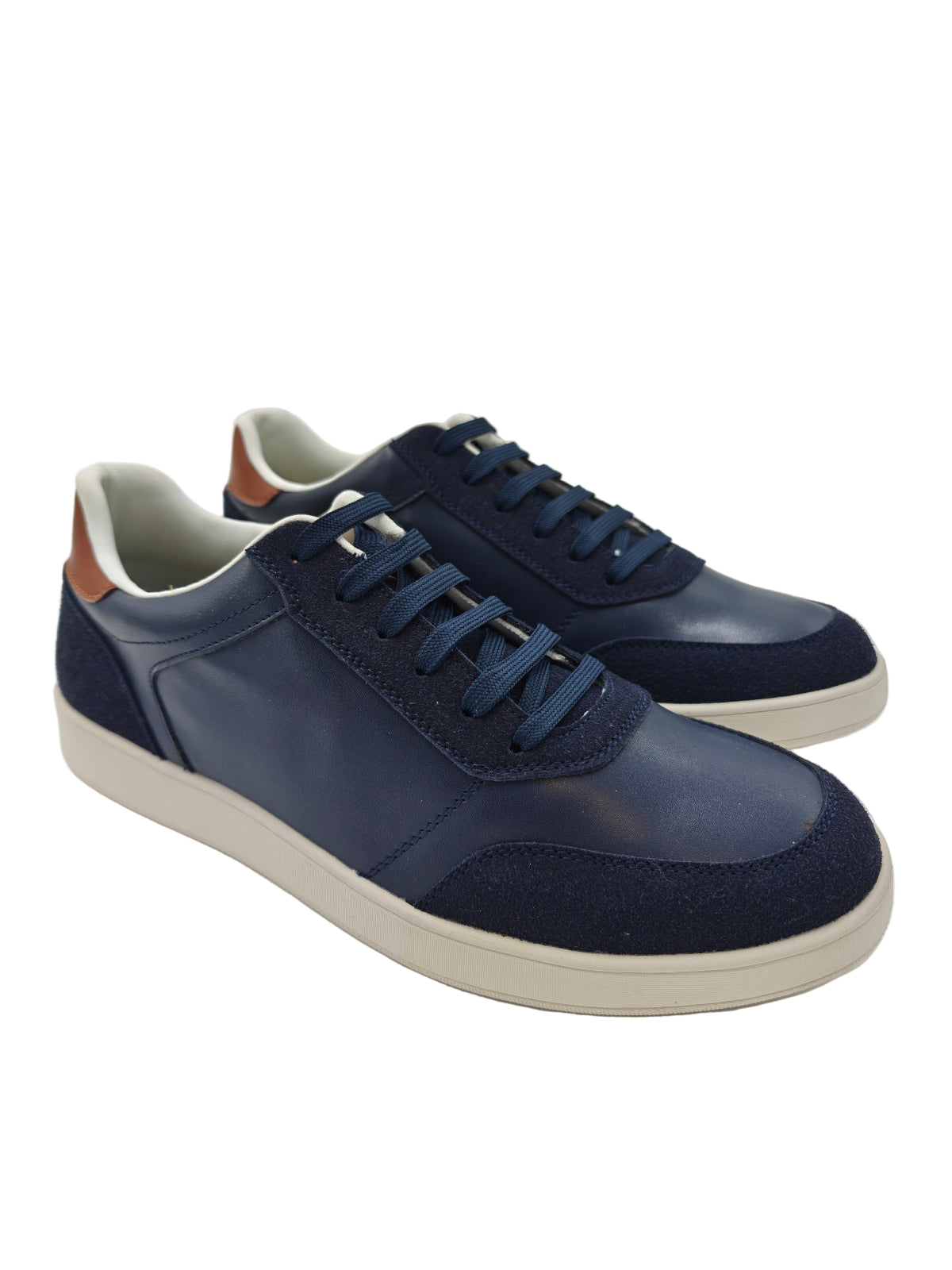Pair of navy blue sneakers with white soles on a white background