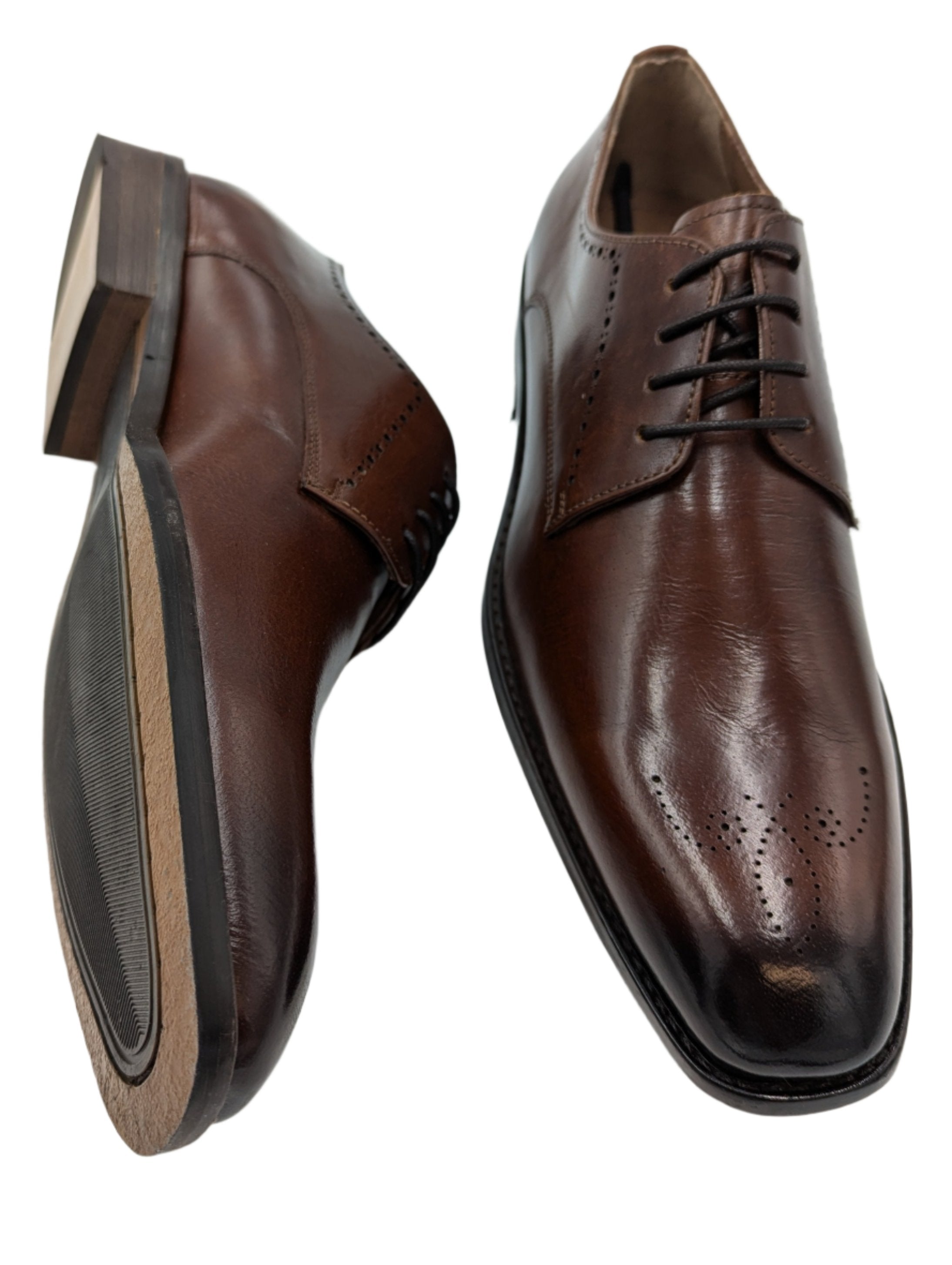 Introducing Benetti Menswear's new Thomas Burgundy Leather shoe. Crafted with luxurious leather and a stylish brogue toe design, these shoes are perfect for any formal occasion. Elevate your style and stand out at weddings, graduations, or any special event.-Sole view