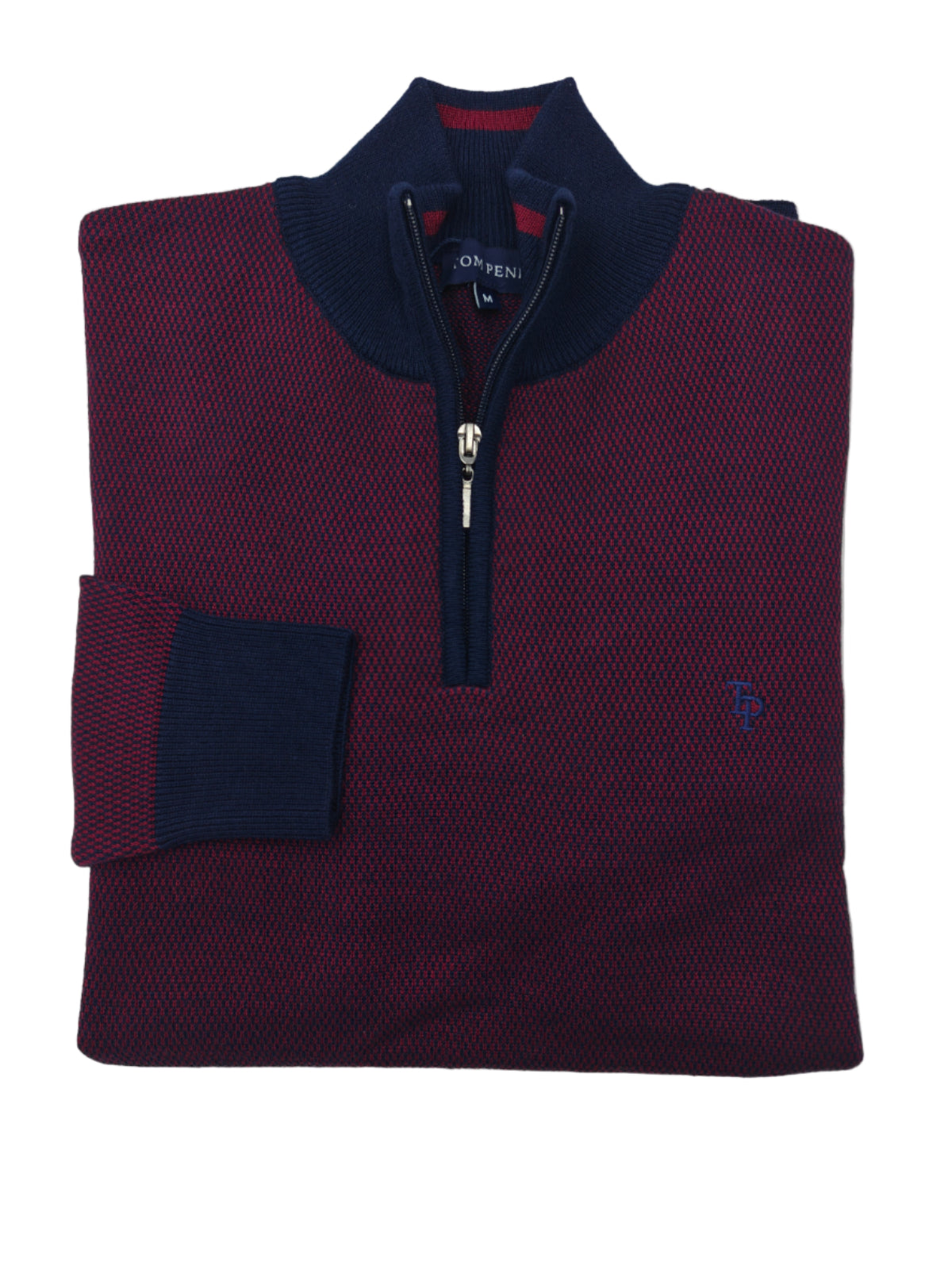 Folded maroon sweater with navy collar and zipper on a white background