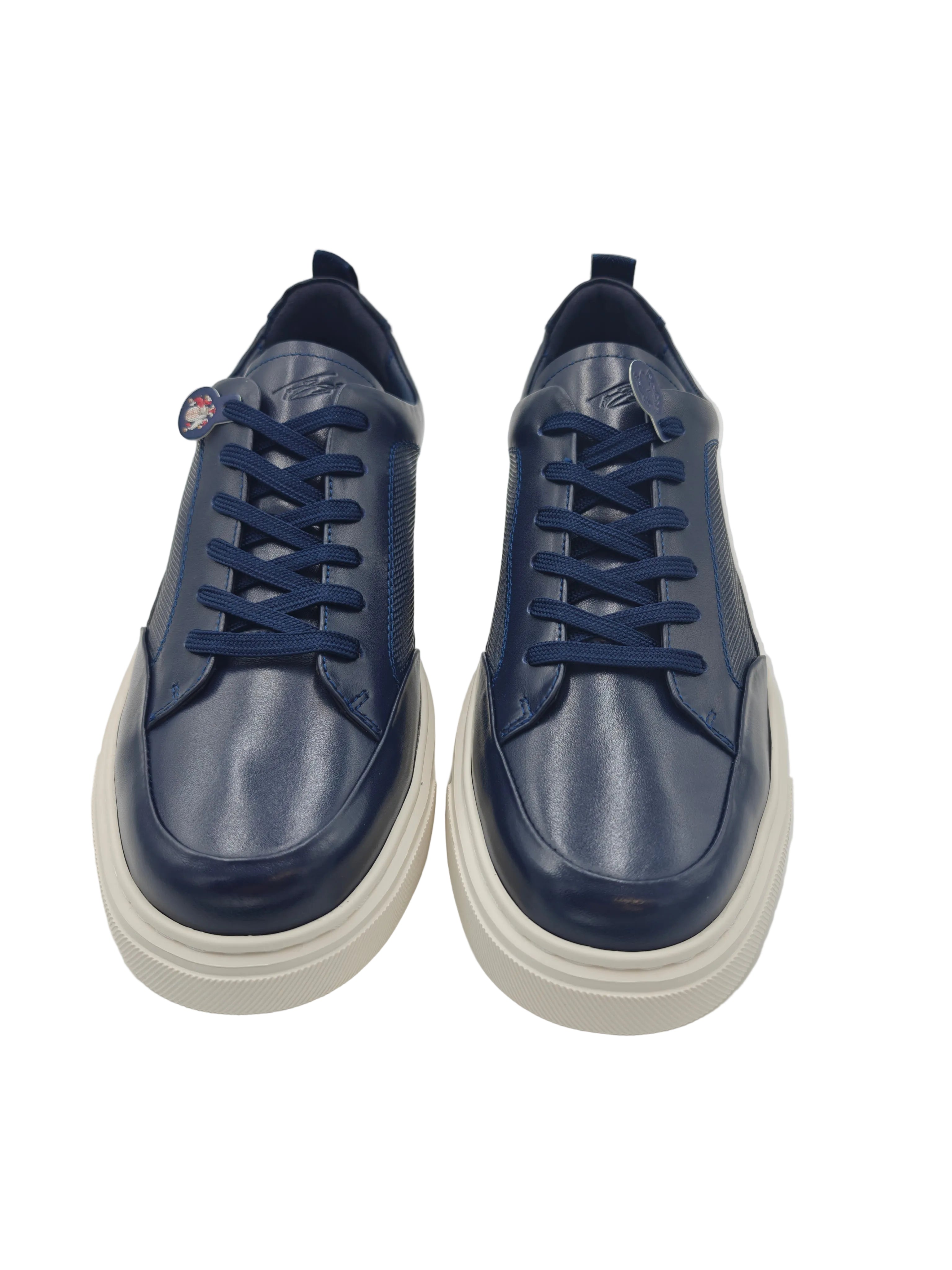 Pair of blue sneakers with white soles on a light gray background