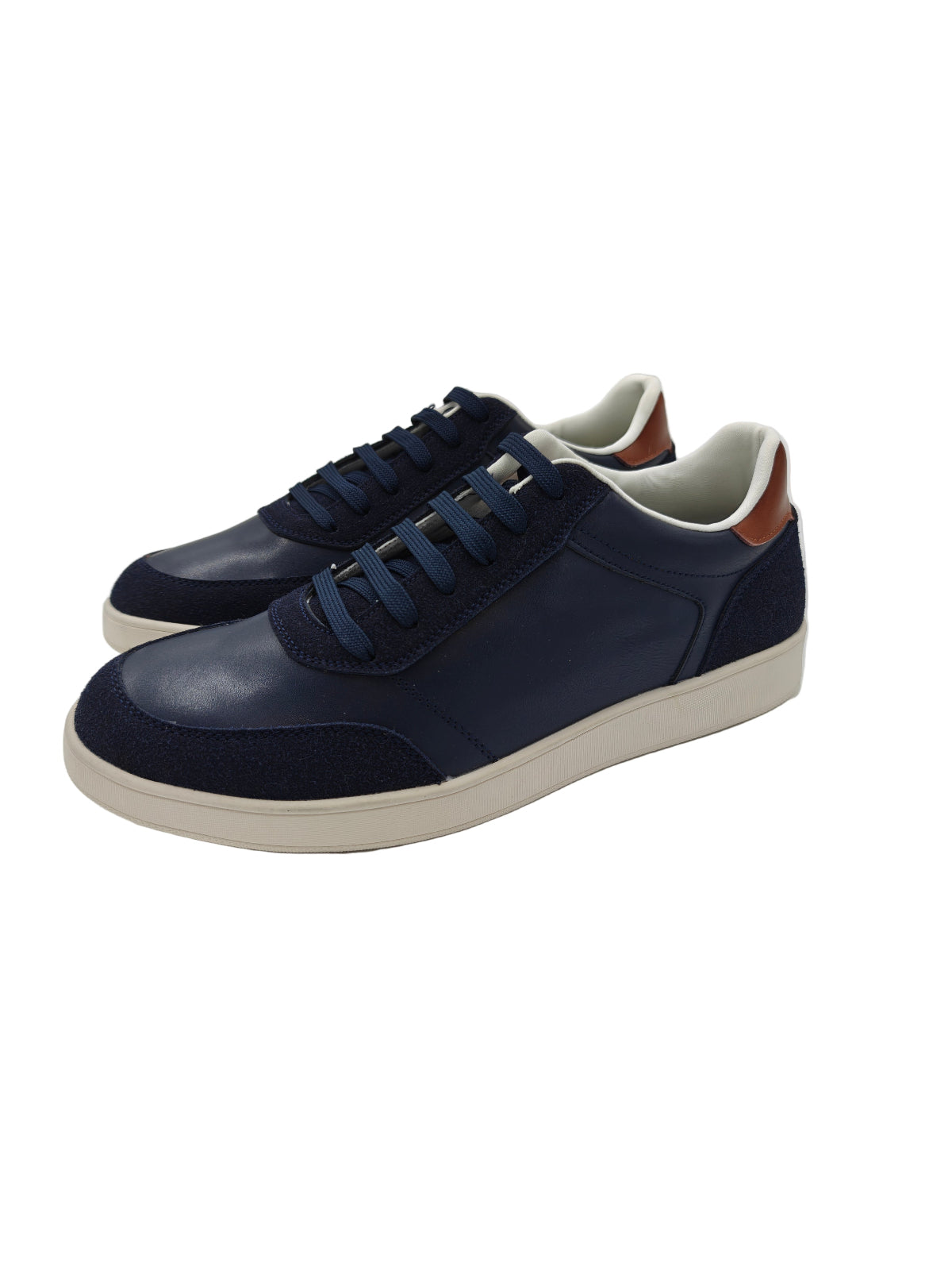 Pair of navy blue sneakers with white soles on a white background