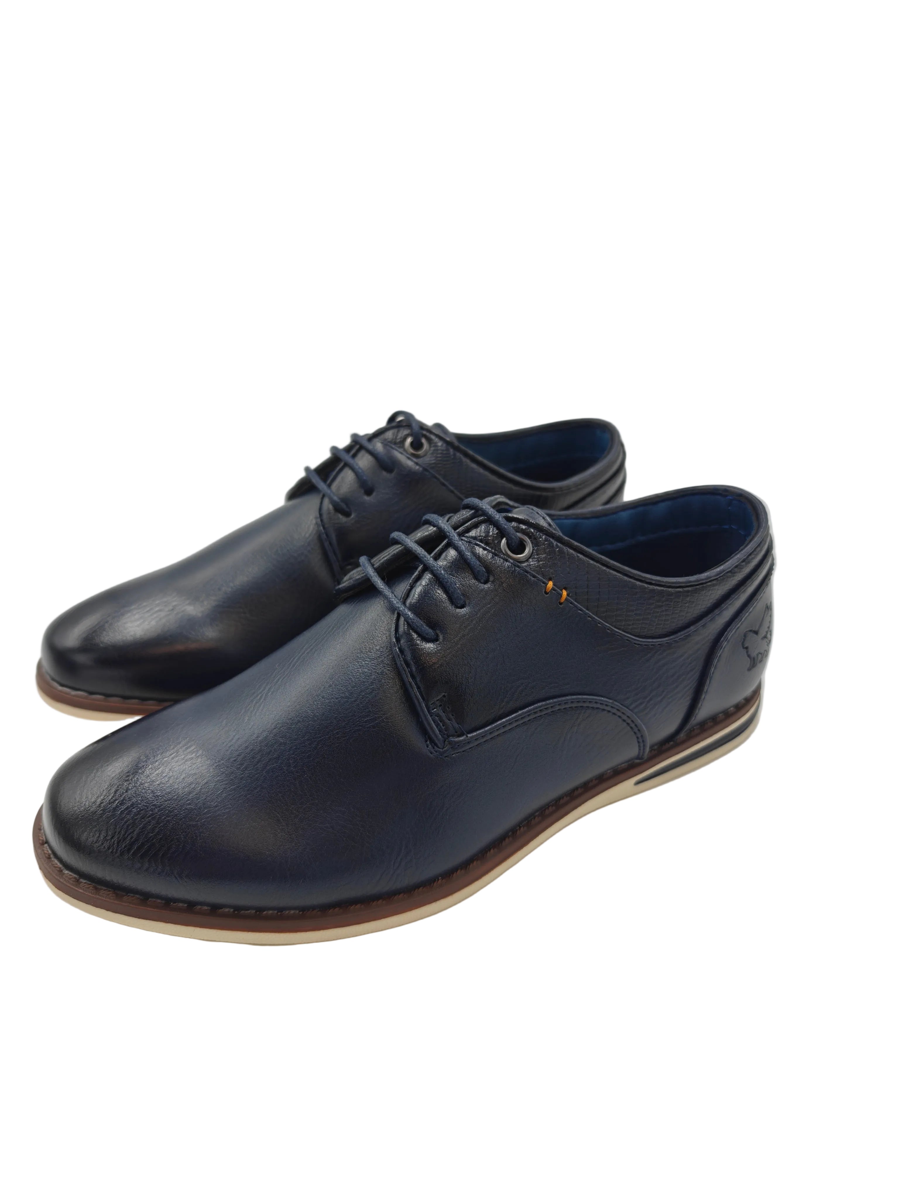 Pair of navy pu blue leather shoes on a white surface with a gray background