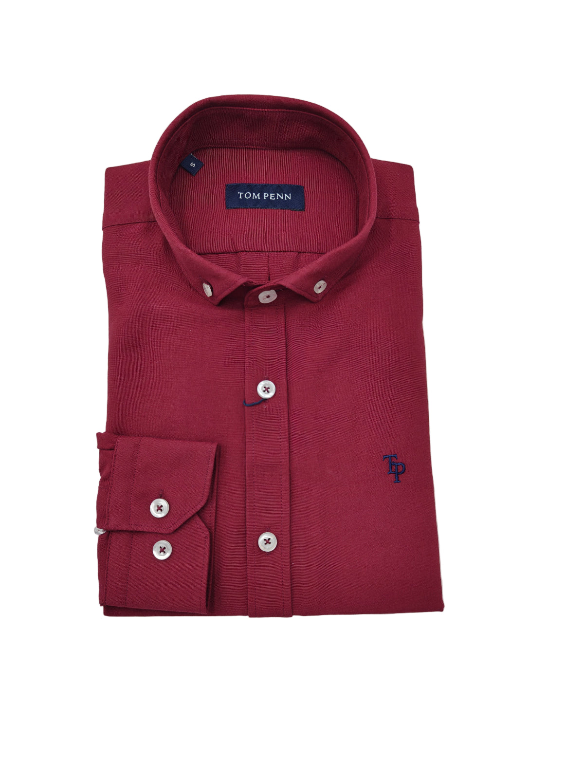 Folded maroon dress shirt with 'Tom Penn' branding on a light gray background
