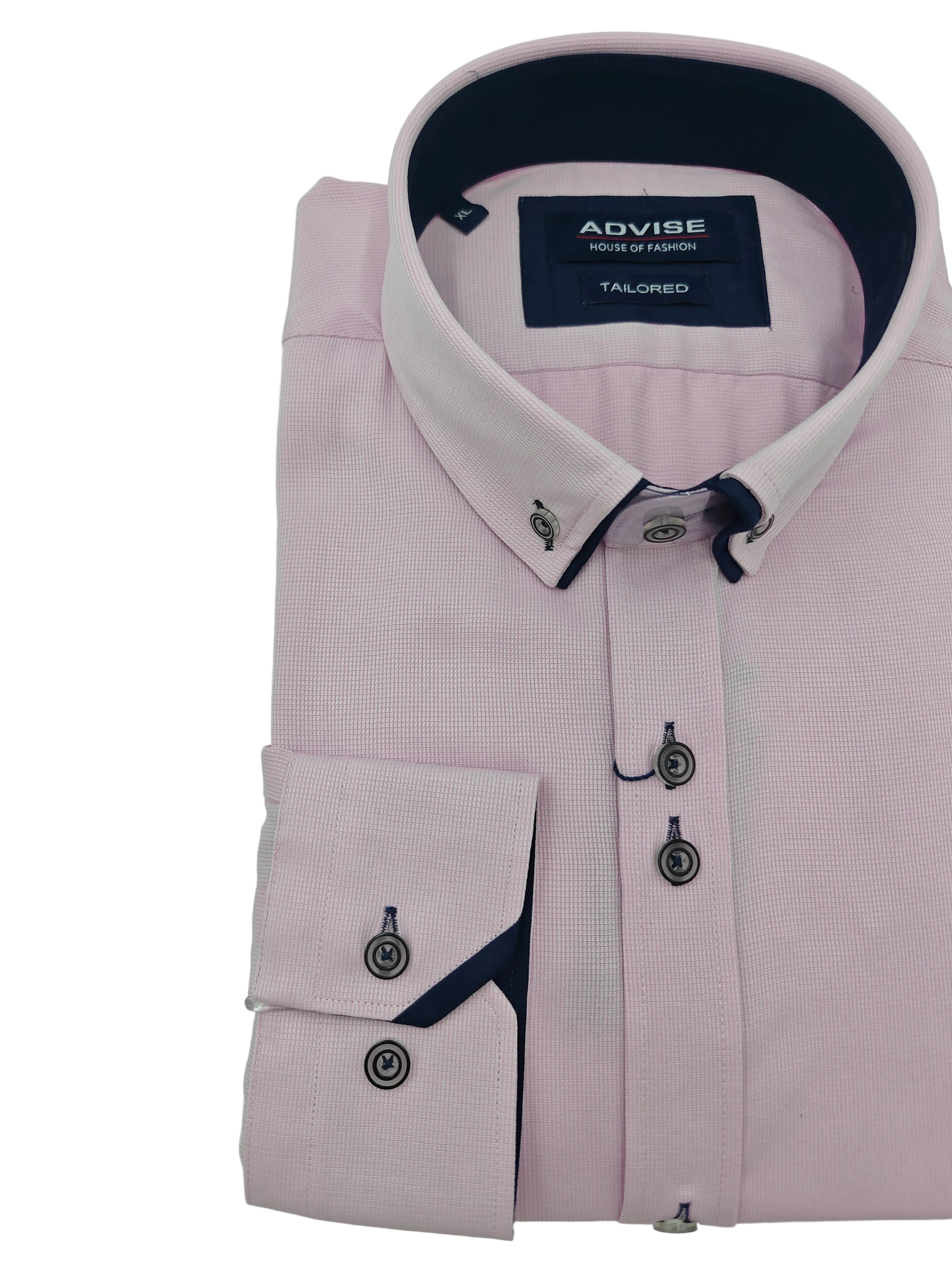Folded pink dress shirt with navy trim and Advise label on a light green background