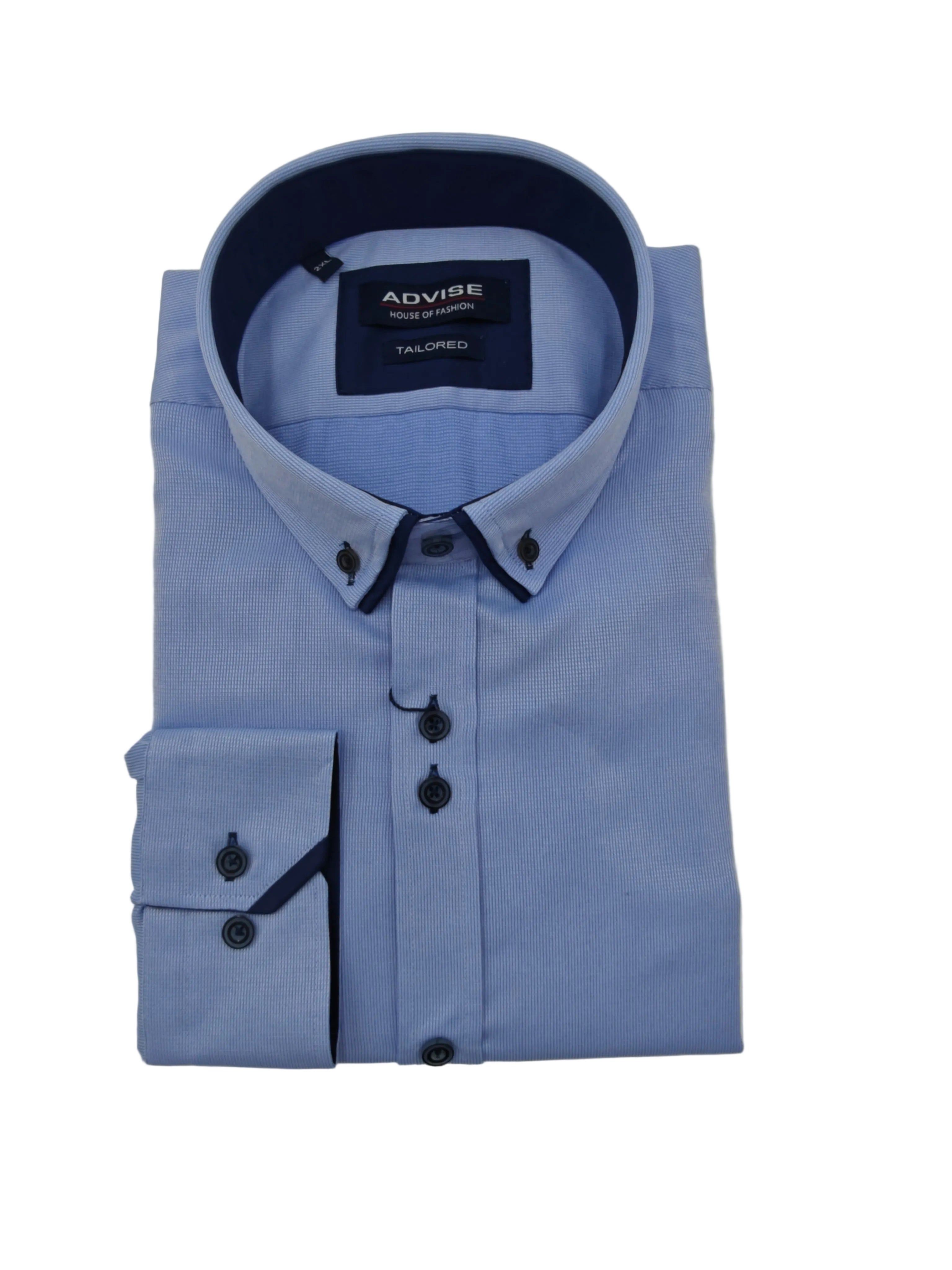 Folded light blue shirt with dark navy collar and buttons on a gray background