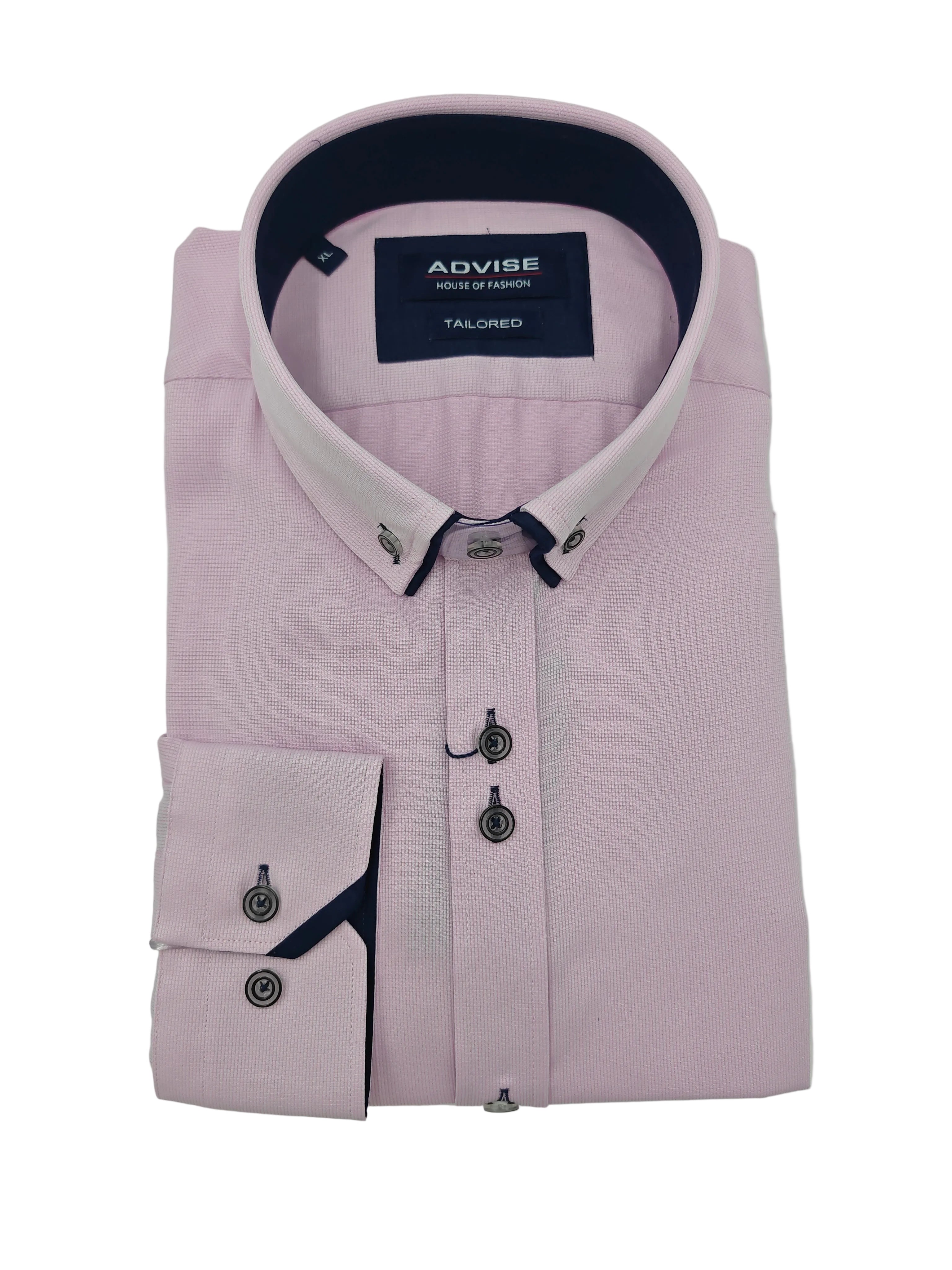 Folded light pink dress shirt with navy accents on a white background