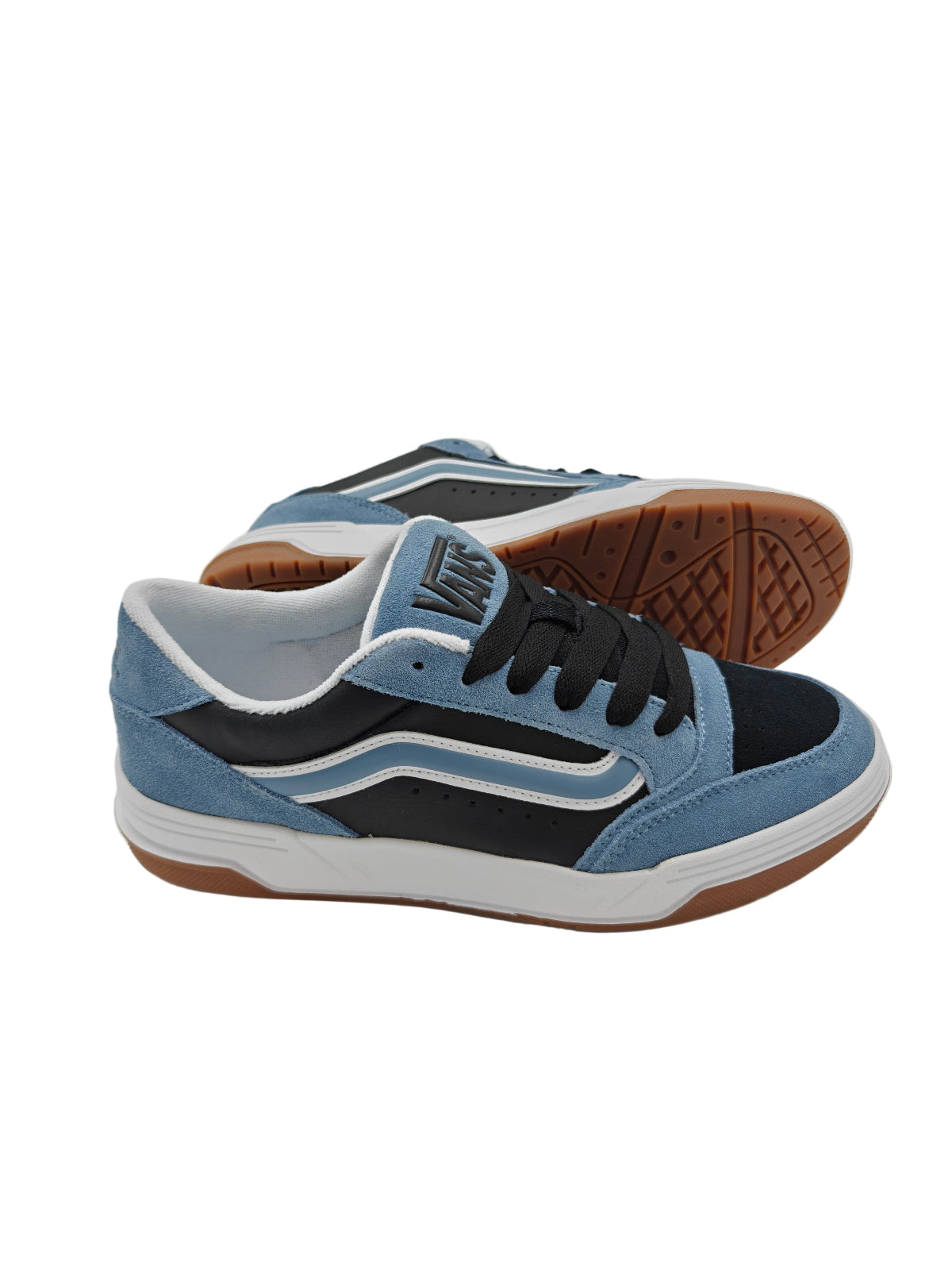 Blue and black sneaker with brown sole on a white surface